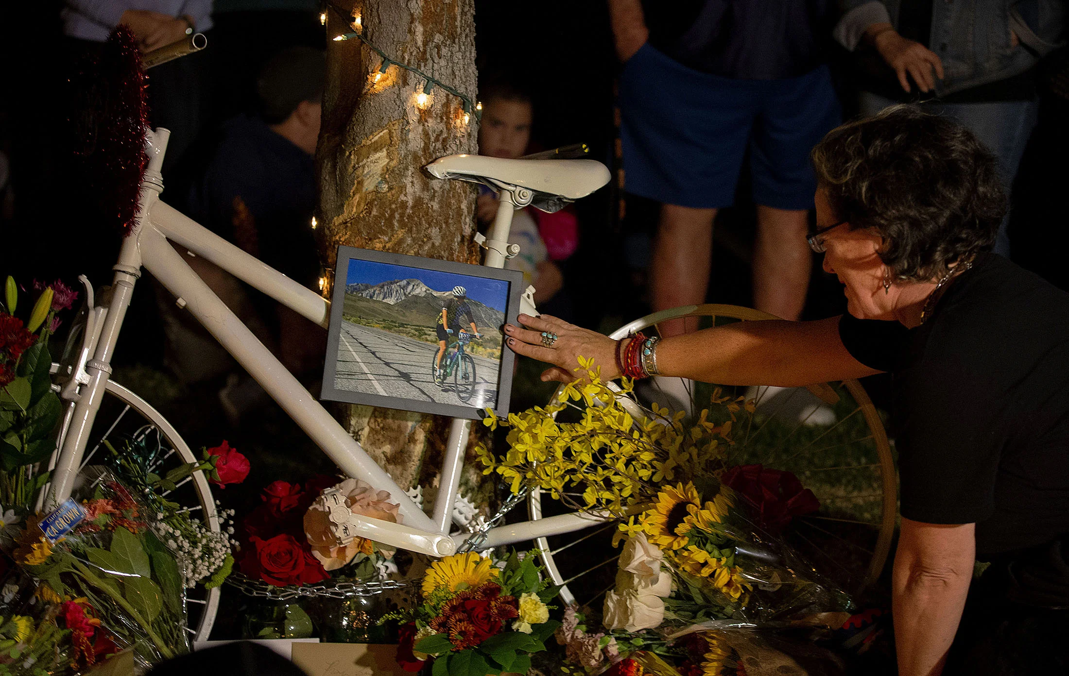 Emotions were high as some friends and family cried while touching the ghost bake place in honor of Leslie Pray, 54, who was killed Saturday while riding her bike along Mills Avenue near Radcliffe Drive, during a candlelight vigil in Claremont on Monday, November 5, 2018.