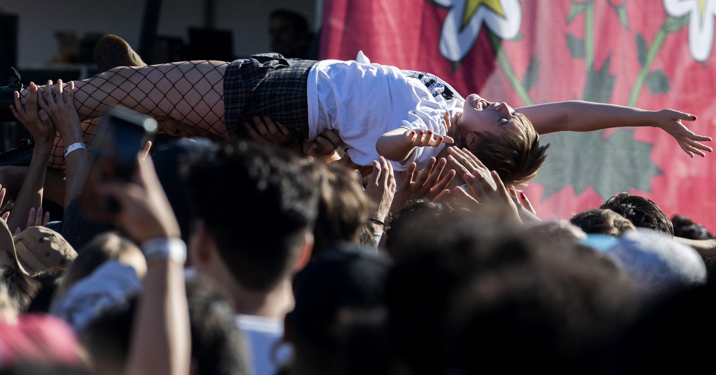  A woman crowd surfs to The Garden as they perform at Tropicalia Festival at the Queen Mary in Long Beach November 3, 2018.  