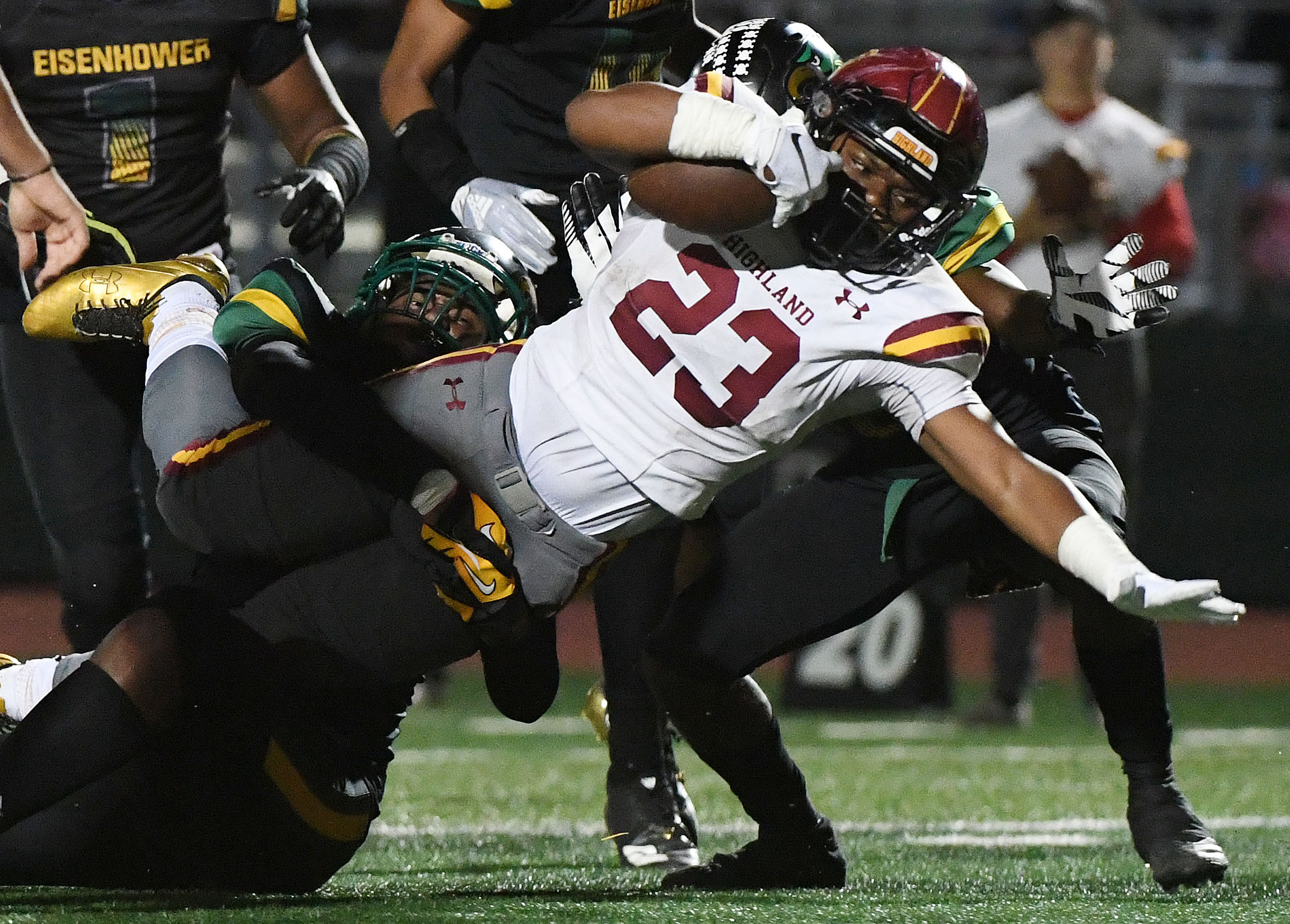  Highlands Jordan Pulliam (23) reaches for extra yardage as he is tackled during the second quarter against Eisenhower. Eisenhower hosts Highland in Rialto, Saturday night November 24, 2018 in a battle of 13-0 teams for the CIF Division 10 prep footb