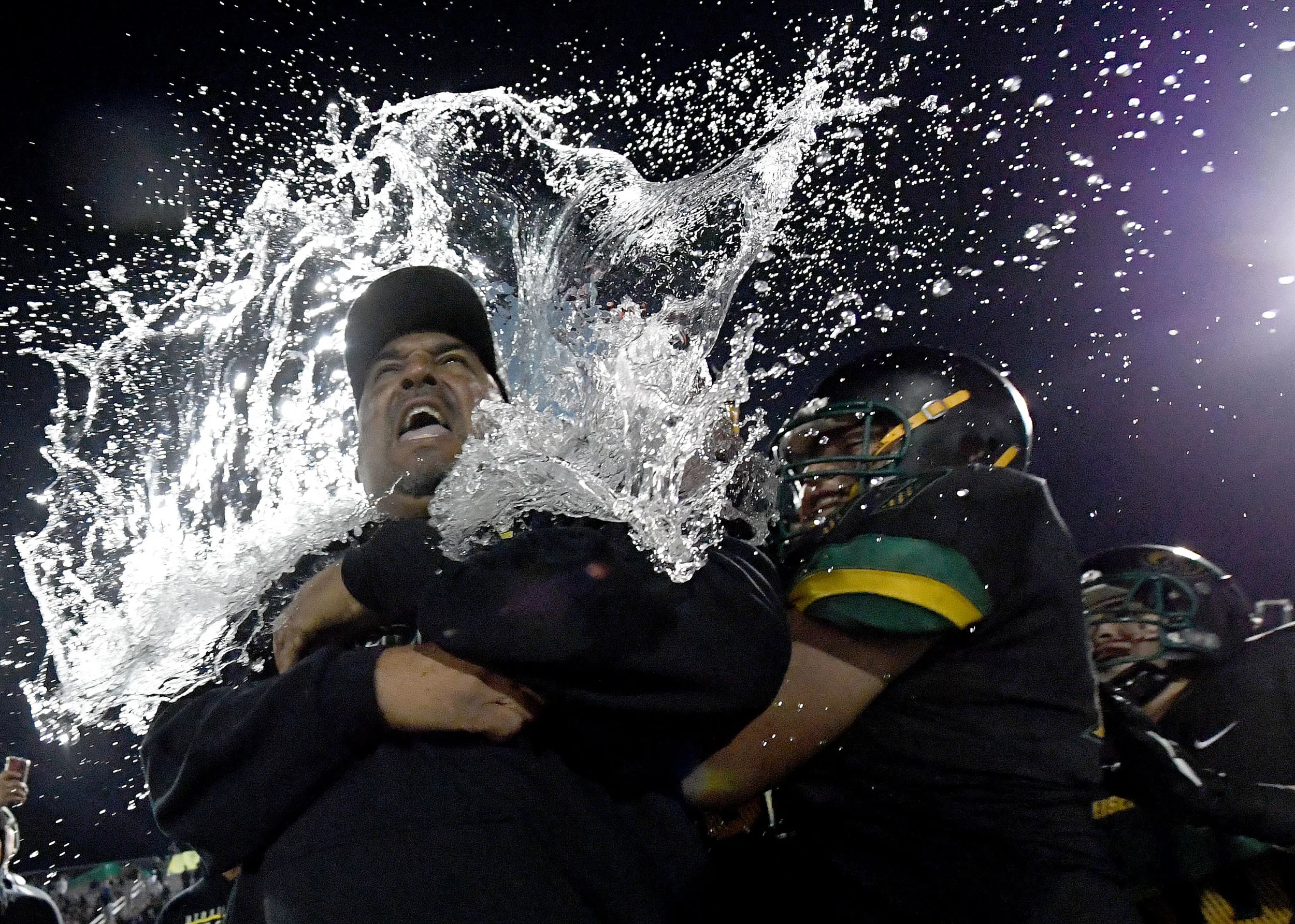  Eisenhower head coach Al Brown gets drenched with water by his players after defeating Highland 35-18 in Rialto, Saturday night November 24, 2018 after winning the CIF Division 10 prep football championship.  