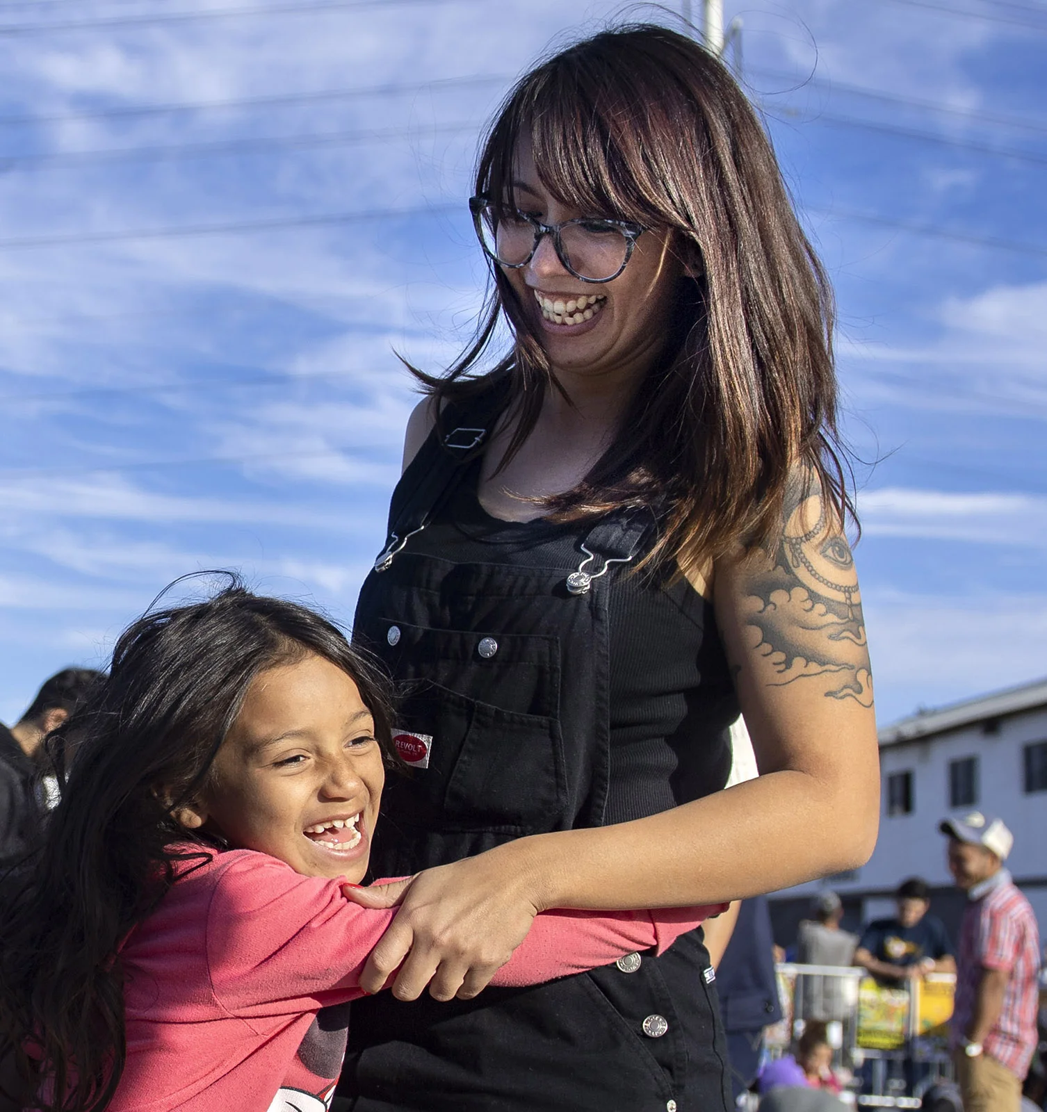 Resa Cole of Los Angeles gets hugged by 8-year-old Ruth, a Honduran migrant outside the El Barretal shelter in Tijuana on Tuesday, December 4, 2018. Cole and her friends have raised more than $15,000 on social media to help the thousands of migrants from Central America.