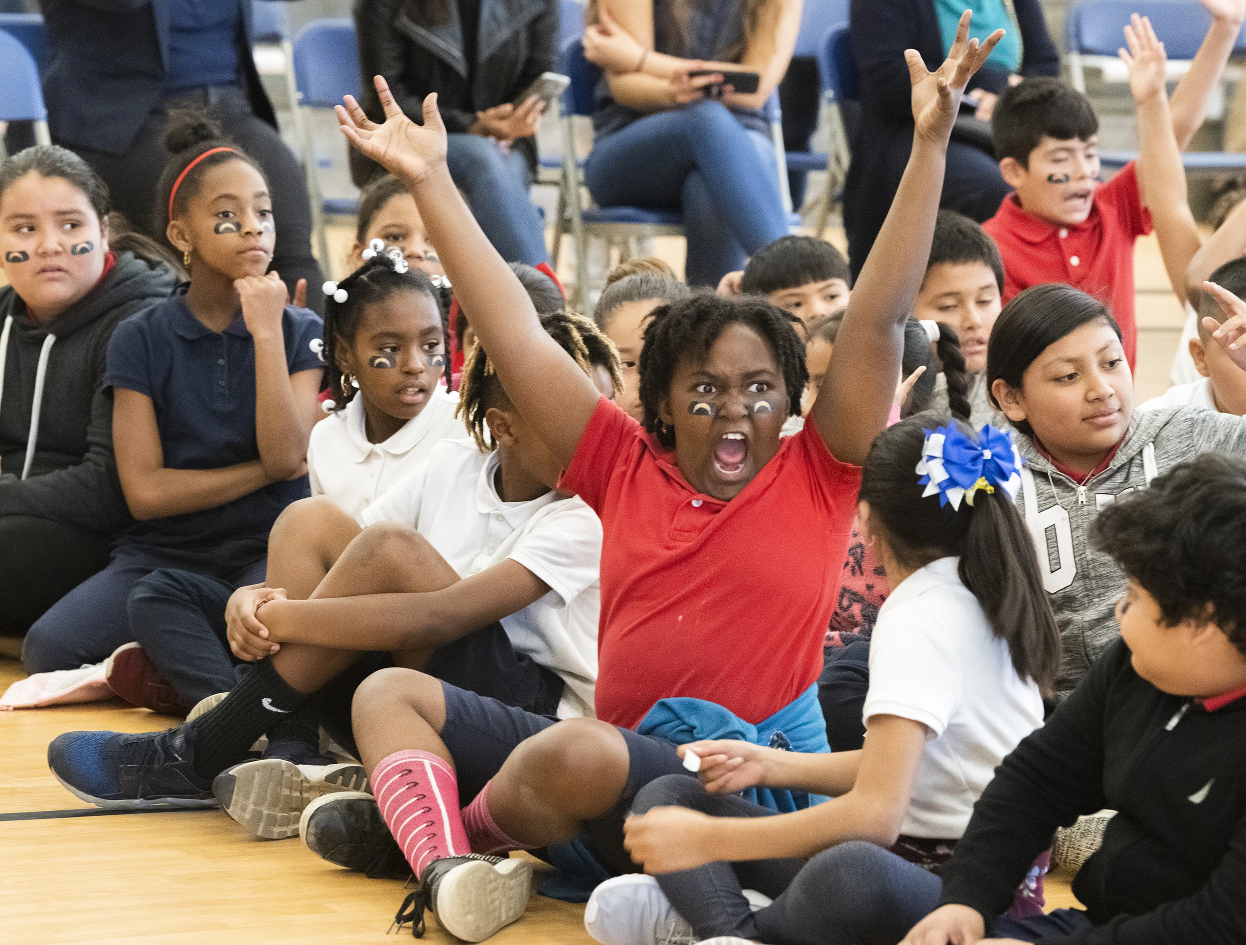  A student reacts at the beginning of the presentation before the Los Angeles Charger players present 150 bikes to 2nd and 3rd-grade students who took part in an essay competition. The bikes were purchased by the team and California Resources Company