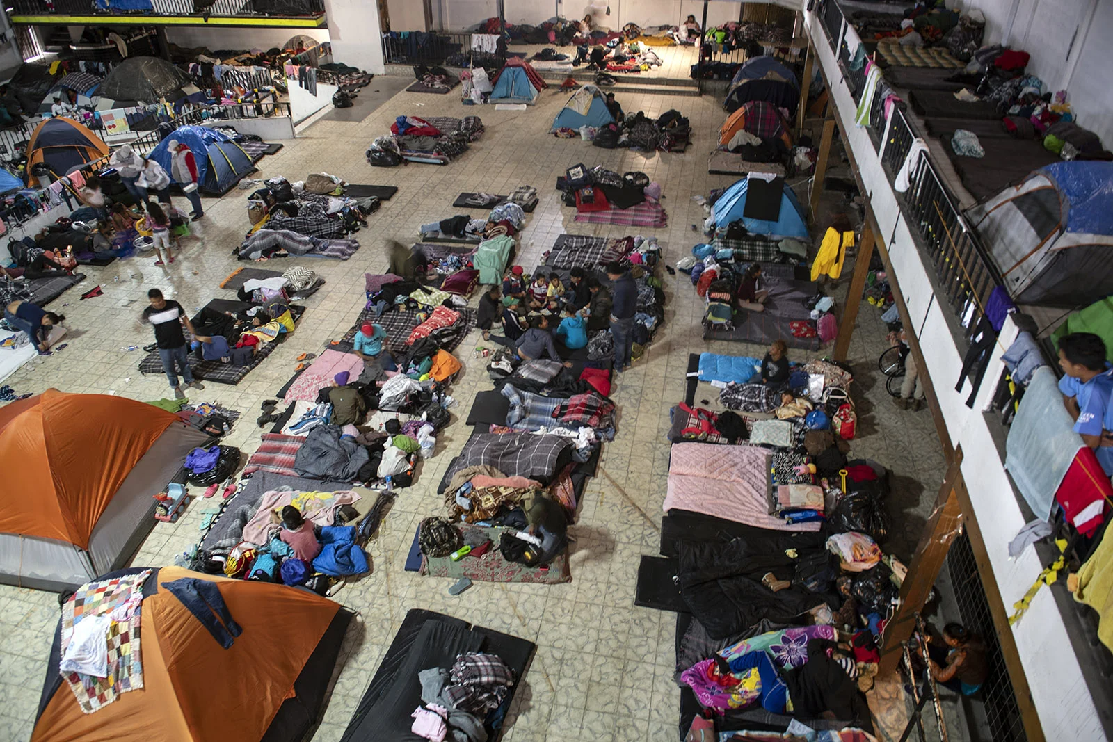 Hundreds of migrants are taking shelter at El Barretal in Tijuana. The inside is dark and features three stories of space with no running water.