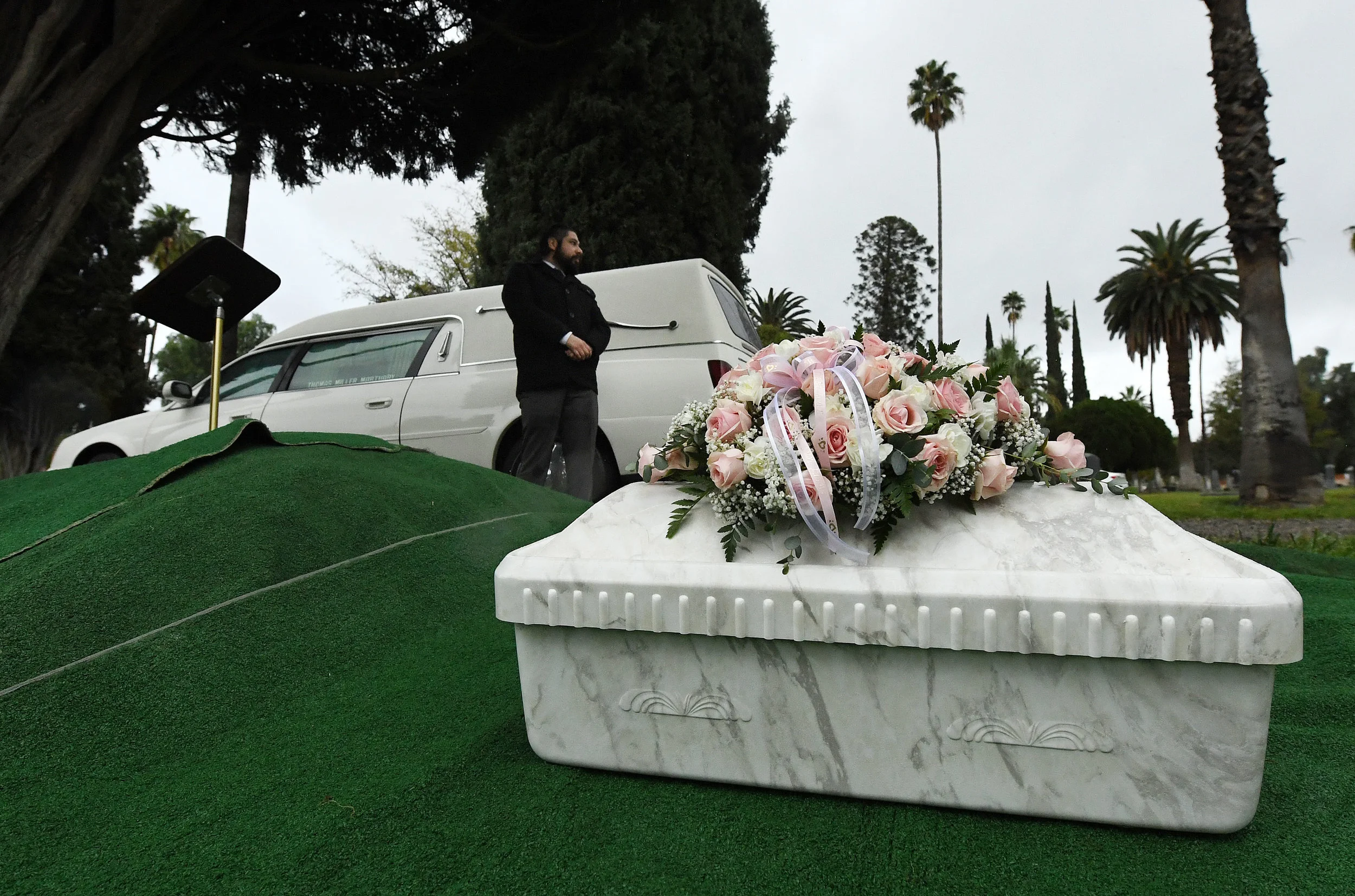  Paul Mariscal, with Thomas Miller Mortuary, stands watch over the casket of Baby Jane Doe prior to her burial at Sunnyslope Cemetery in Corona, Thursday, December 6, 2018. The newborn infant was found in a cardboard box near the 15 freeway in Corona