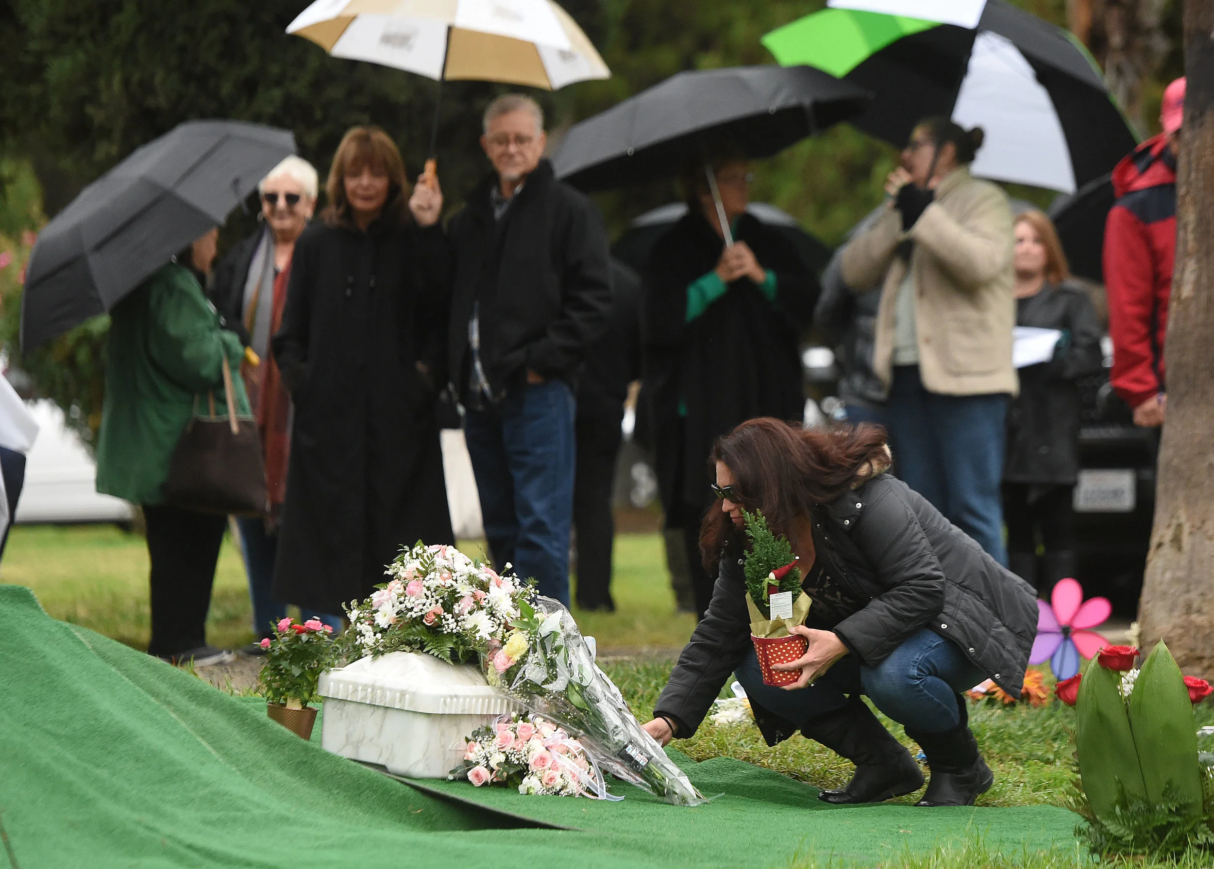  Lorena Palacios, from Corona, places flowers next to the small casket containing the remains of Baby Jane Doe at Sunnyslope Cemetery in Corona, Thursday, December 6, 2018. The newborn infant was found in a cardboard box near the 15 freeway in Corona