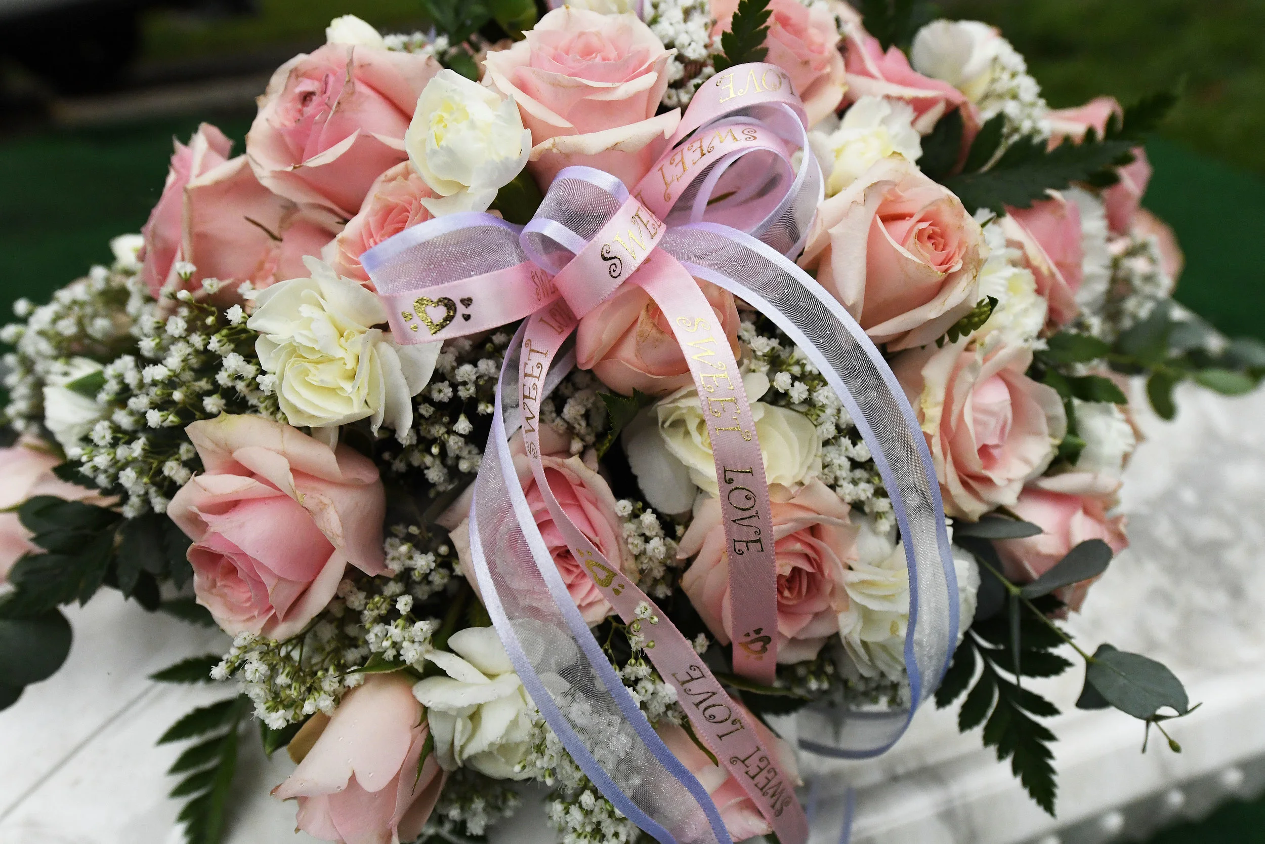  Flowers sit atop the small casket of Baby Jane Doe prior to her burial at Sunnyslope Cemetery in Corona, Thursday, December 6, 2018. The newborn infant was found in a cardboard box near the 15 freeway in Corona in July. Corona police and fire depart