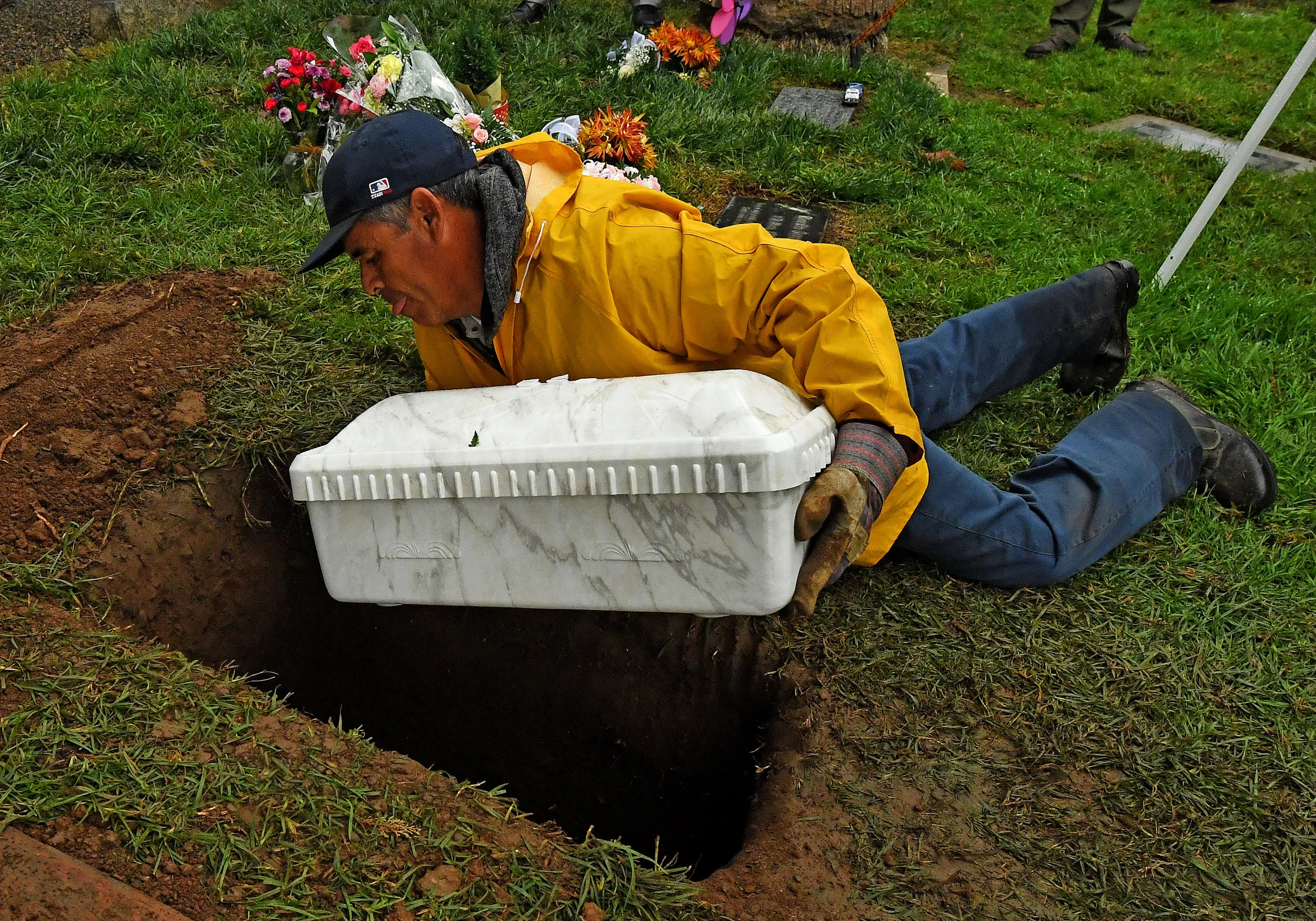  Internment employee Lupe Gaytan places the casket of Baby Jane Doe into her final resting place at Sunnyslope Cemetery in Corona, Thursday, December 6, 2018. The newborn infant was found in a cardboard box near the 15 freeway in Corona in July. Coro