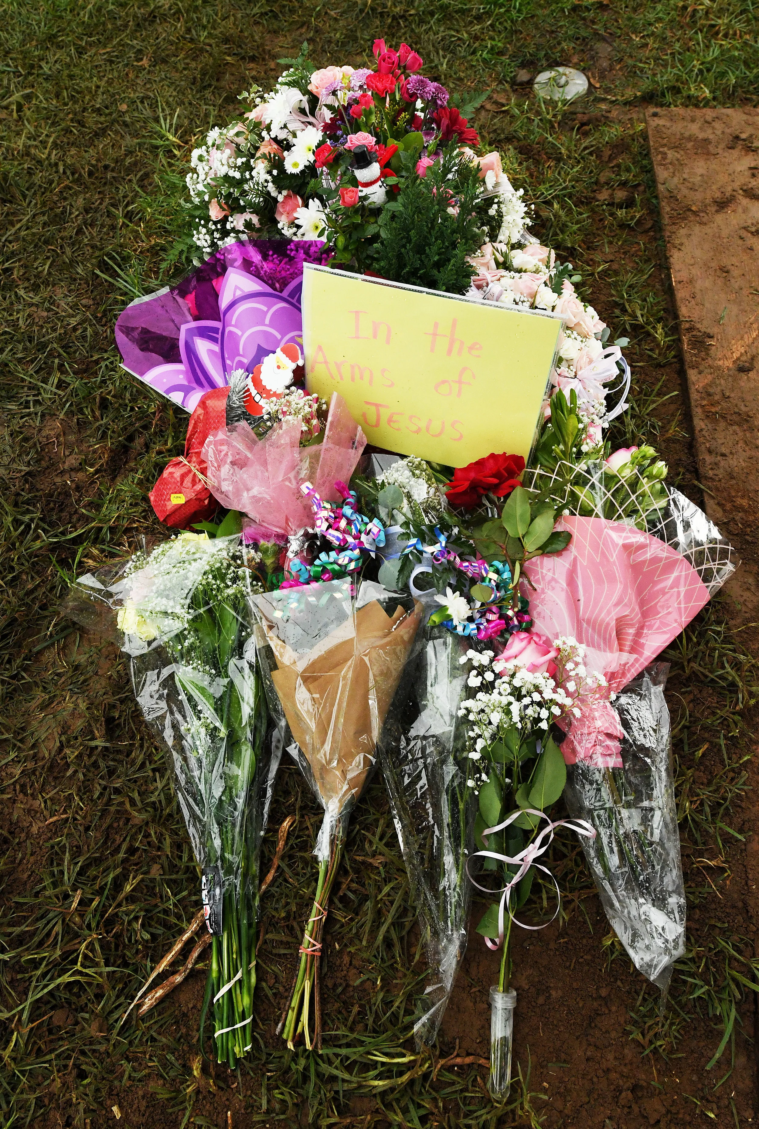  Flowers sit atop the grave of Baby Jane Doe at Sunnyslope Cemetery in Corona, Thursday, December 6, 2018 following the infants burial. The newborn infant was found in a cardboard box near the 15 freeway in Corona in July. Corona police and fire depa