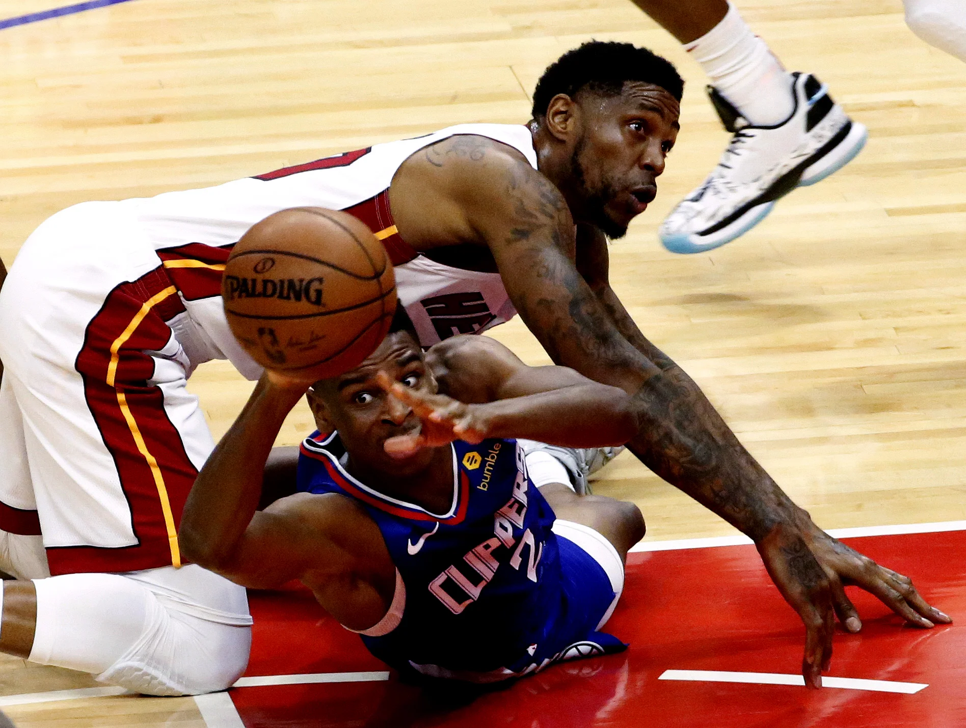 Los Angeles Clippers' Shai Gilgeous-Alexander, bottom, and Miami Heats' Udonis Haslem battle for a ball during an NBA game in Los Angeles on Dec. 8, 2018.

 