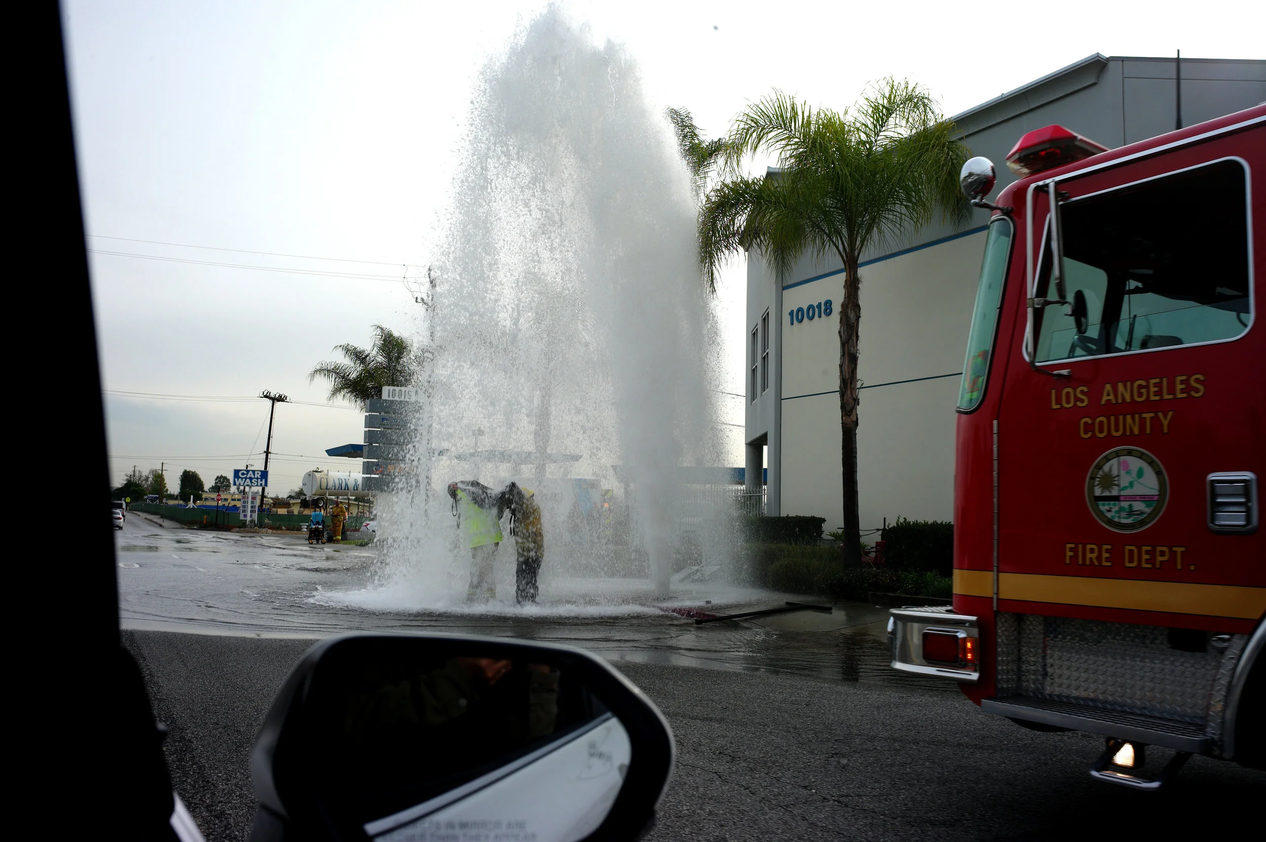  Firefighters try to turn off a broken water main on Lower Azusa road in El Monte on Dec. 21, 2018.  