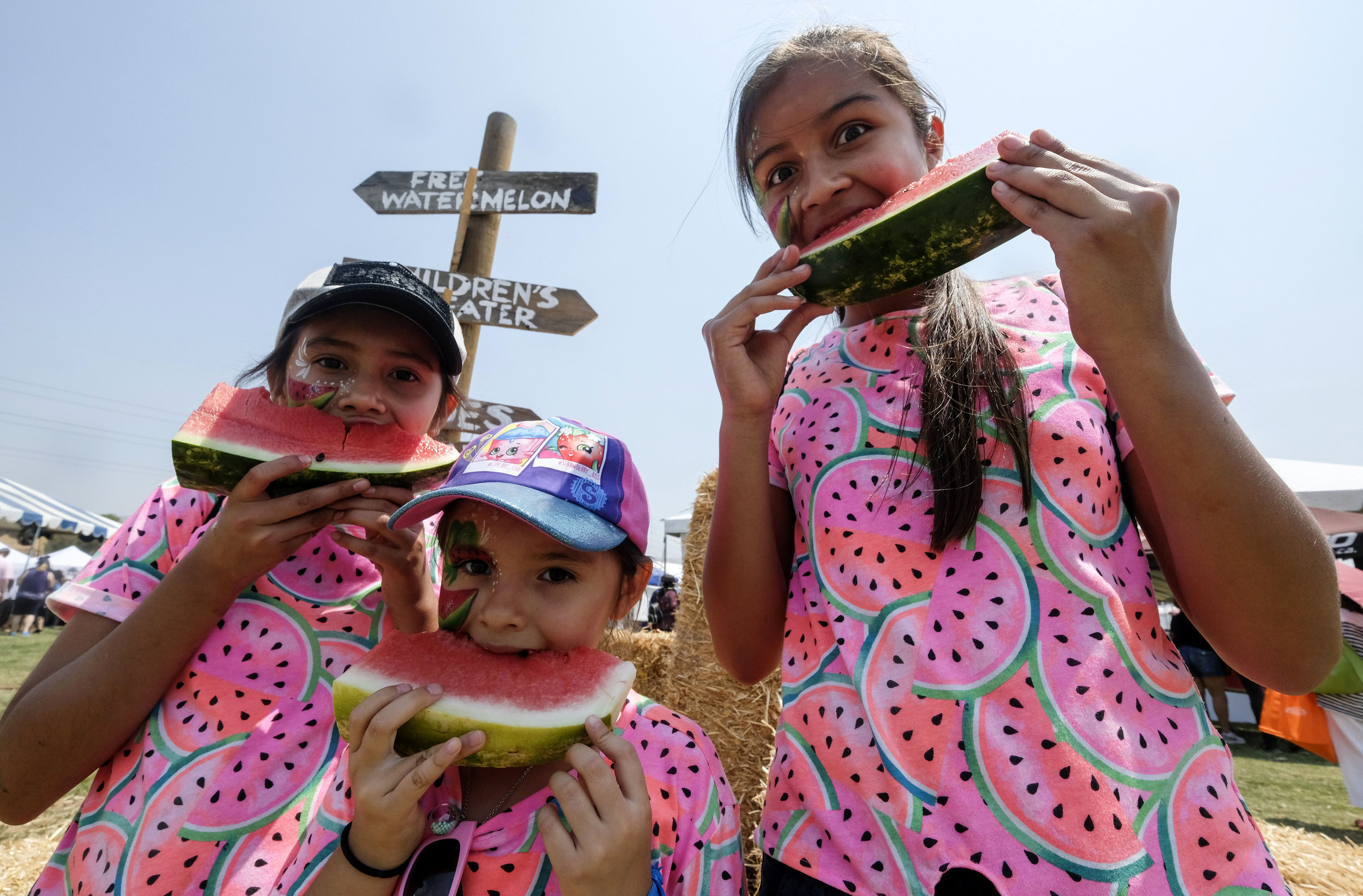  People eat watermelon at the 56th Annual California Watermelon Festival in Los Angeles, Saturday, July 28, 2018. 