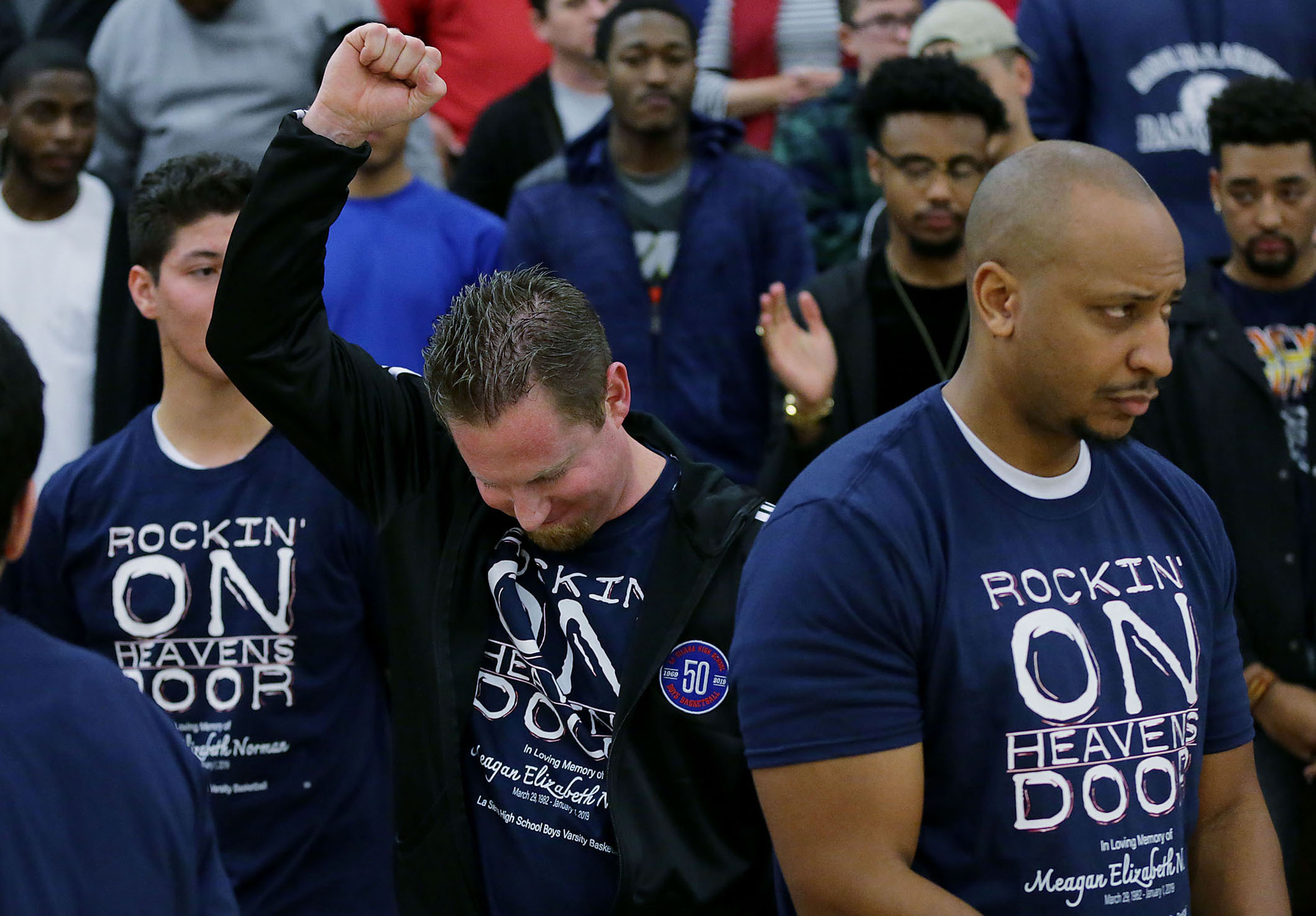 La Sierra boys basketball coach Justin Norman pumps his fist to thank the fans and supporters after a moment of silence his wife, Meagan, who's sudden death 10 days ago shocked the La Sierra sporting family in Riverside on Friday, January 11, 2019.