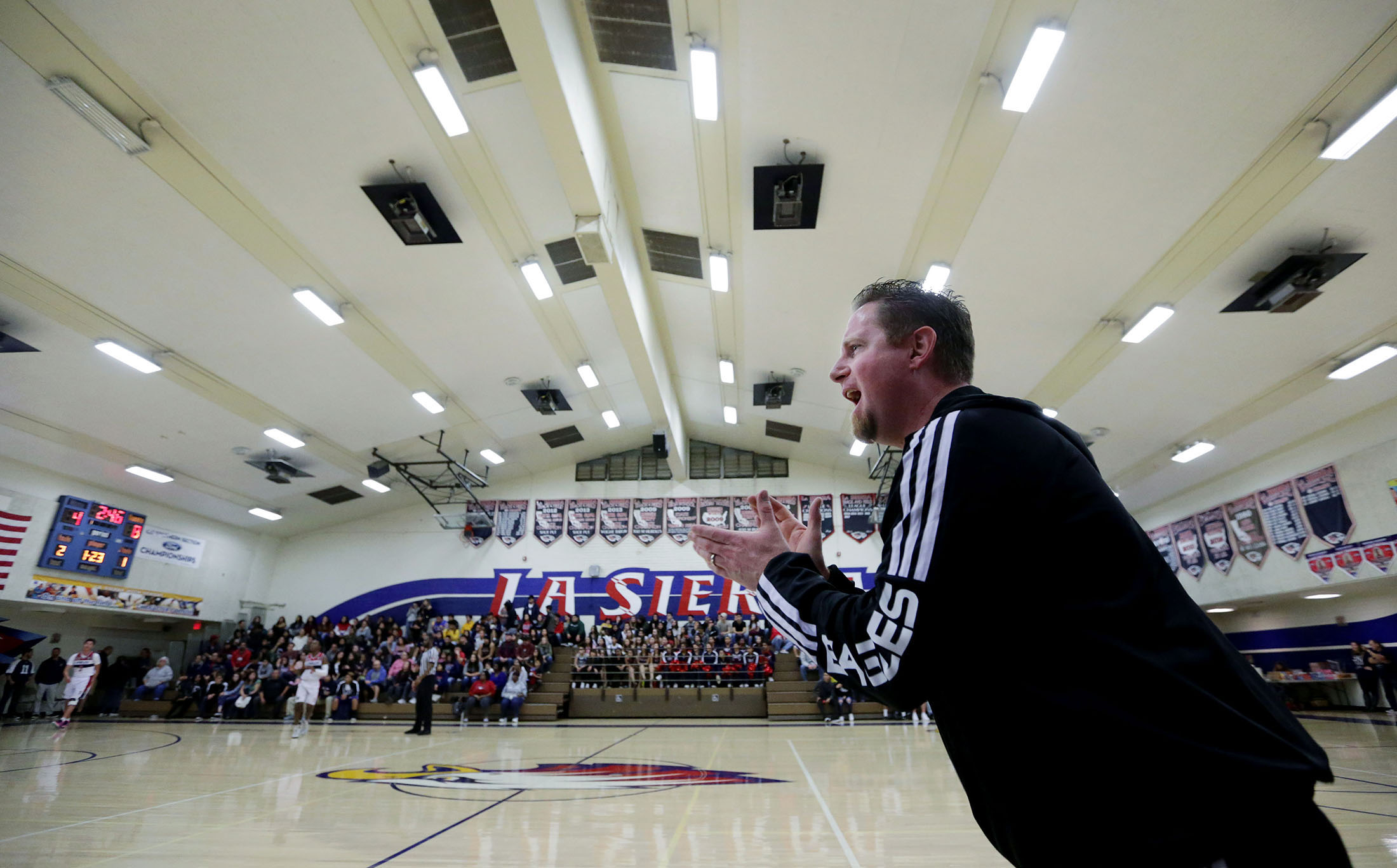 La Sierra boys basketball coach Justin Norman barks out orders to his team center court as he coach the Eagles against Patriot at La Sierra High School in Riverside on Friday, January 11, 2019.