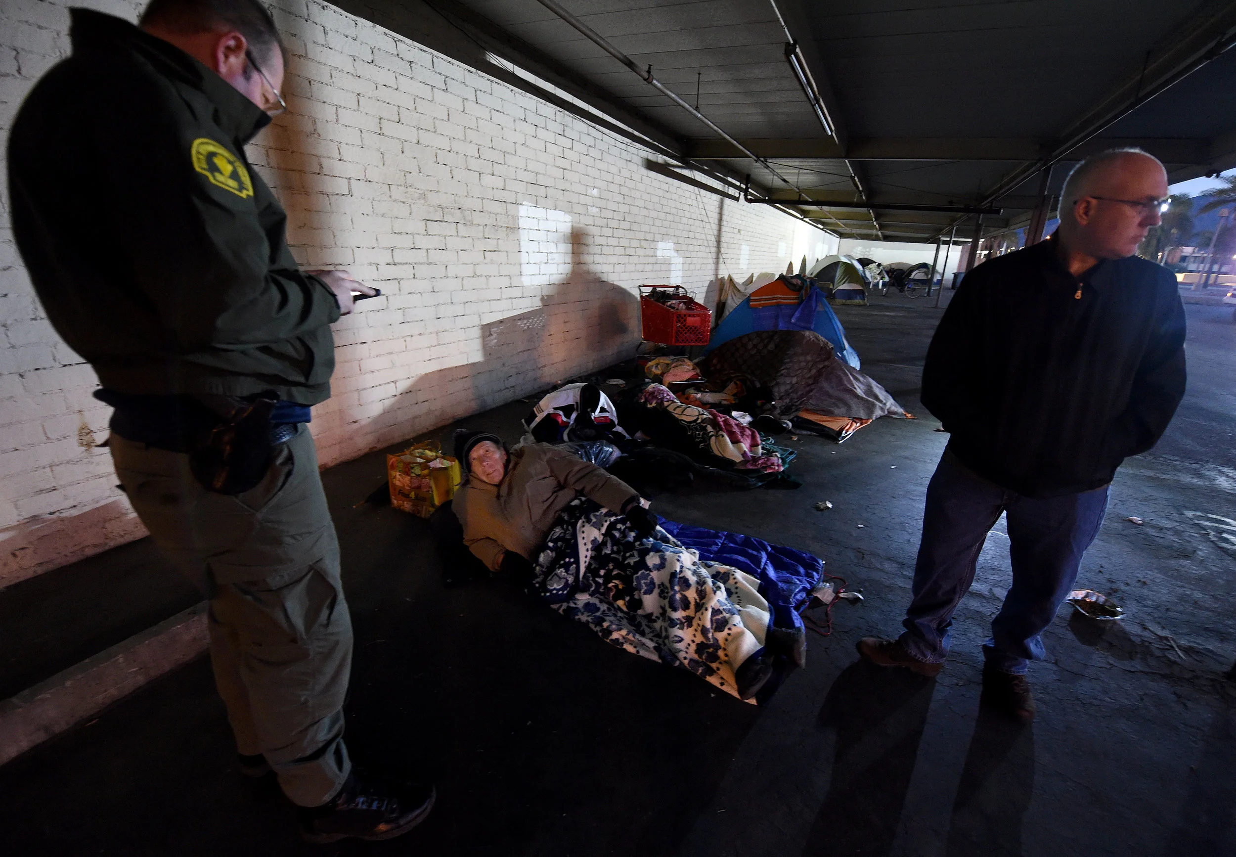  San Bernardino County Sheriff deputy Mike Jones (left) gathers information from veteran Steven Carlson, 72, as San Bernardino County CEO Gary McBride observes during the San Bernardino County 2019 Point-in-Time Homeless Count in downtown San Bernard