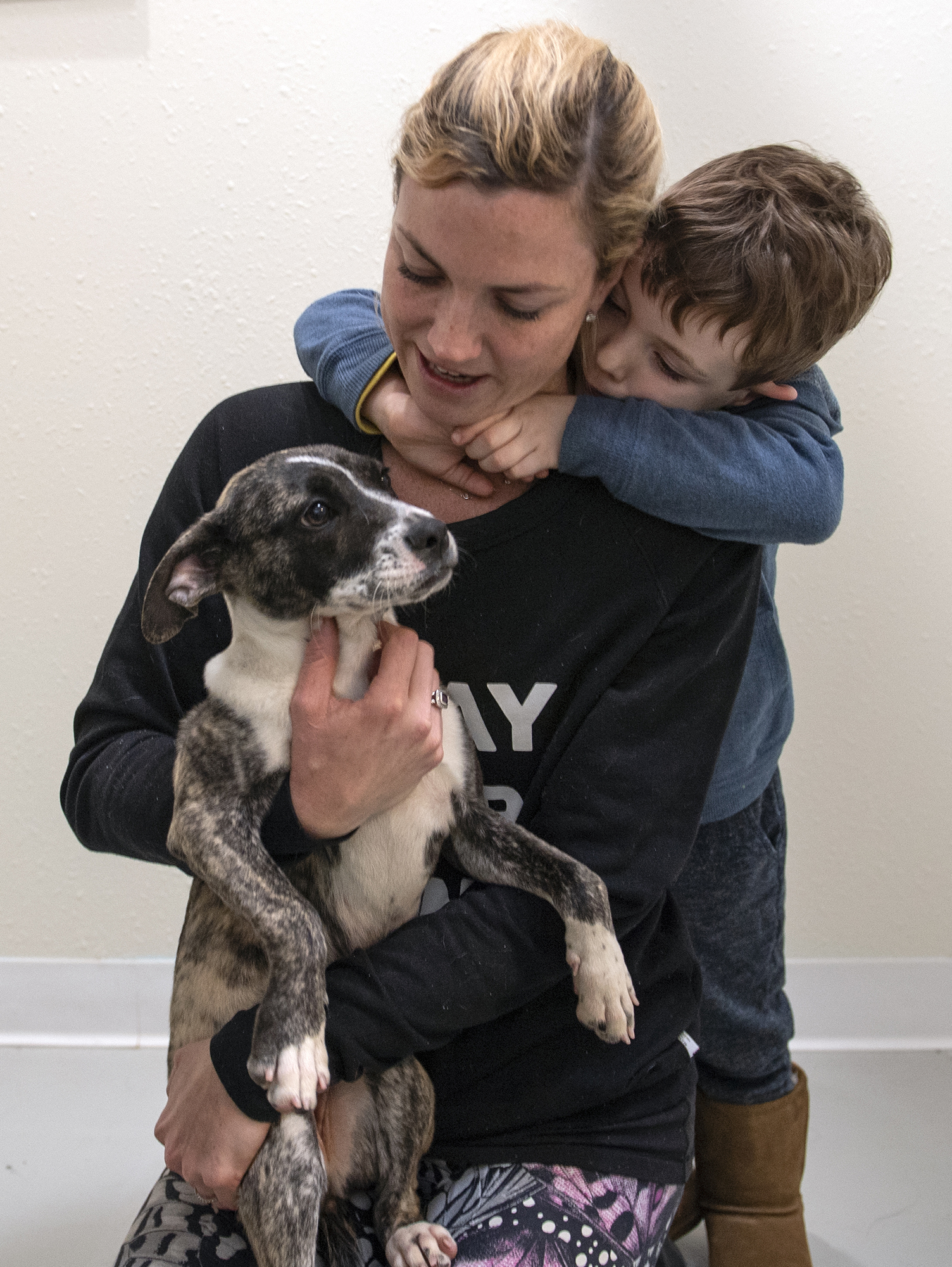Amy Kraus and her son Kent, 3, decide that this shepherd/boxer mix is the right dog for their family during opening day of The Orphanage, a no-kill shelter in Costa Mesa on Saturday, January 12, 2019. The family's previous dog died in October.