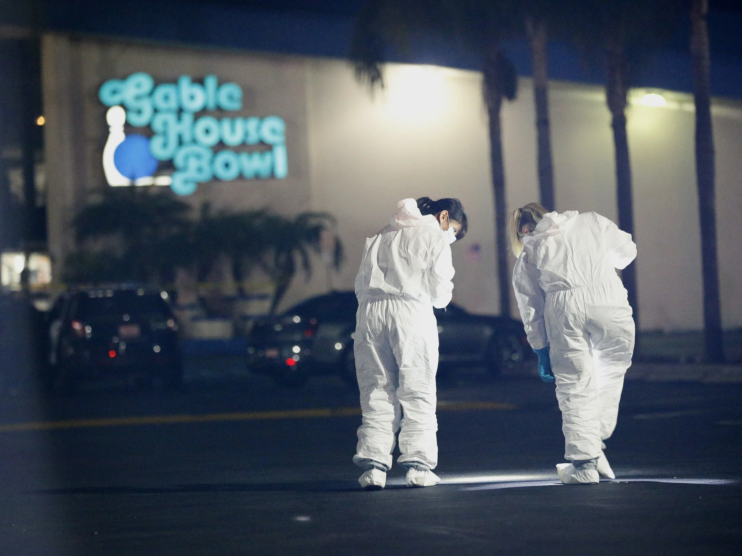  Police officers and investigators work the scene after a fatal shooting in Torrance, California, Saturday, Jan. 5, 2019. Three people died in a shooting at a bowling alley in Torrance and four others were injured, authorities said. 