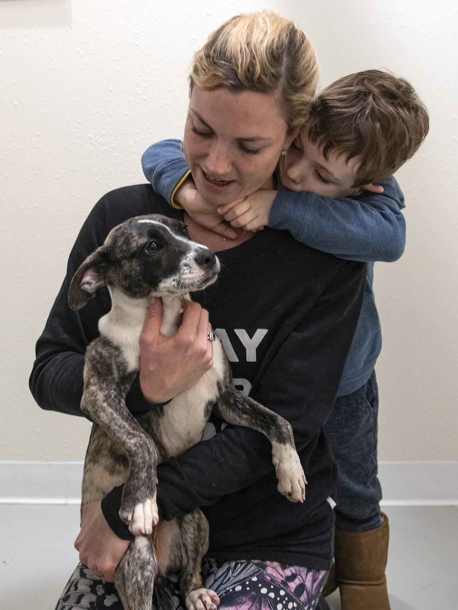 Amy Kraus and her son Kent, 3, decide that this shepherd/boxer mix is the right dog for their family during opening day of The Orphanage, a no-kill shelter in Costa Mesa on Saturday, January 12, 2019. The family's previous dog died in October.