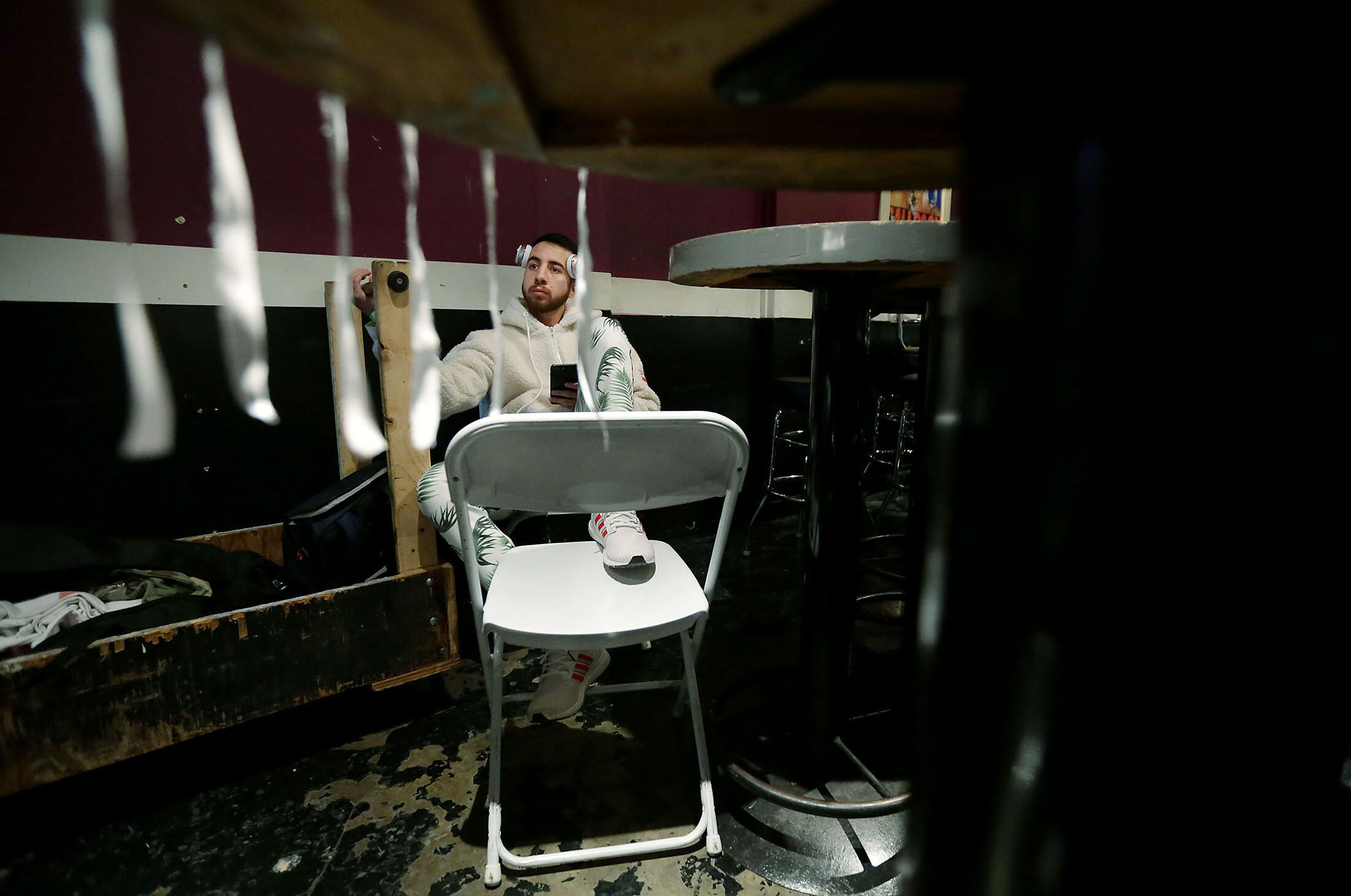 Waiting in the dressing room is not always exciting as Carlos Saucedo listens to music with more then an hour to go to box Misael Chacon in their super featherweight bout at Florentine Gardens in Hollywood on Saturday, February 16, 2019. PUBLISHED F