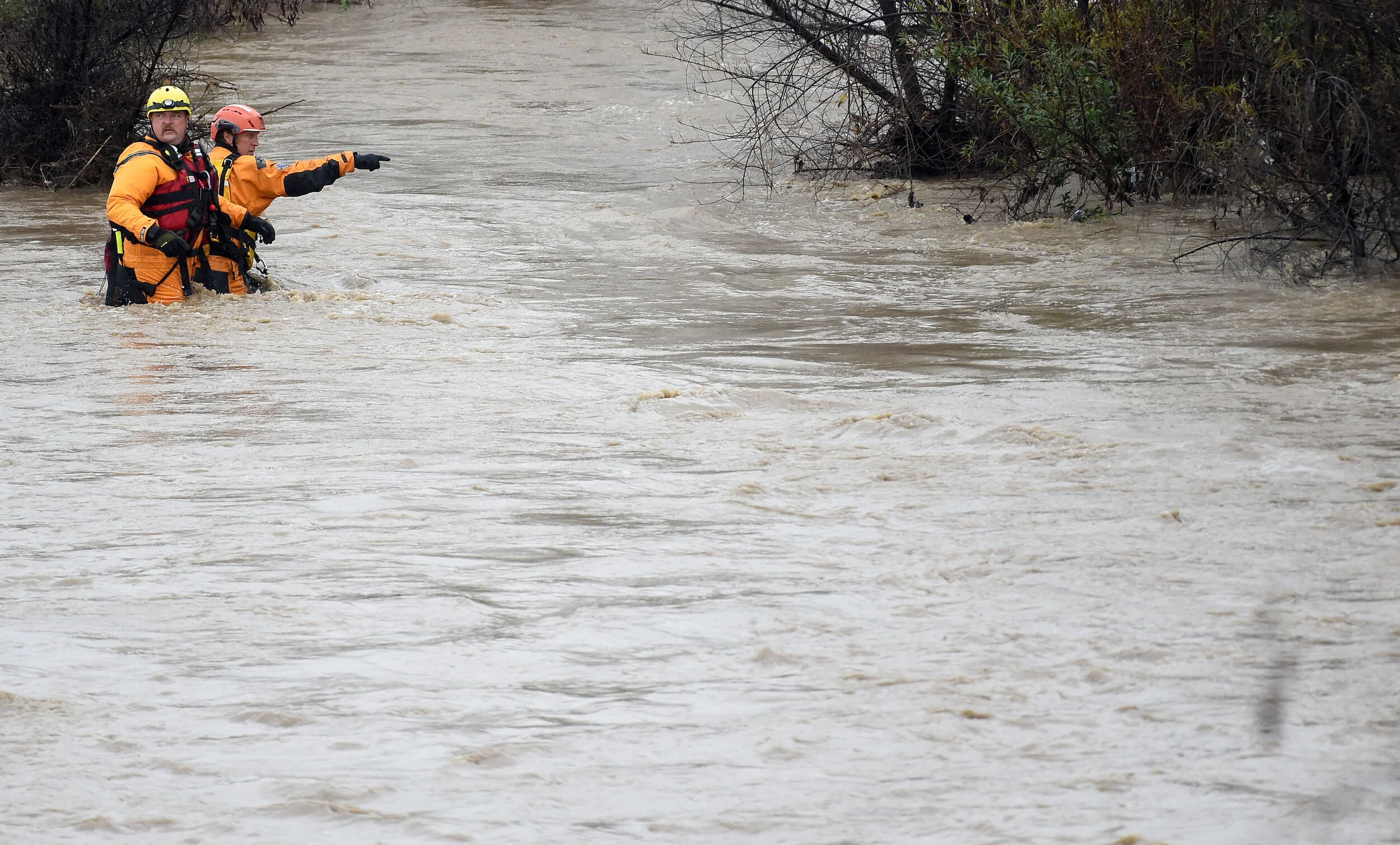  A San Bernardino County Fire swift rescue team prepares to cross the Santa Ana River to rescue 8 stranded individuals Thursday. A San Bernardino County Fire swift rescue team rescued 8 individuals stranded on an island in the rain swollen Santa Ana 