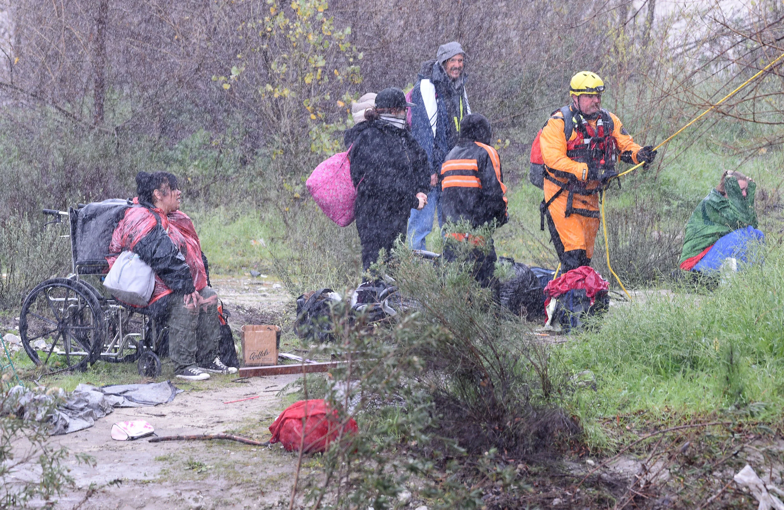  A San Bernardino County Fire swift rescue team rescued 8 individuals stranded on an island in the rain swollen Santa Ana River bed Thursday, February 14, 2019.  