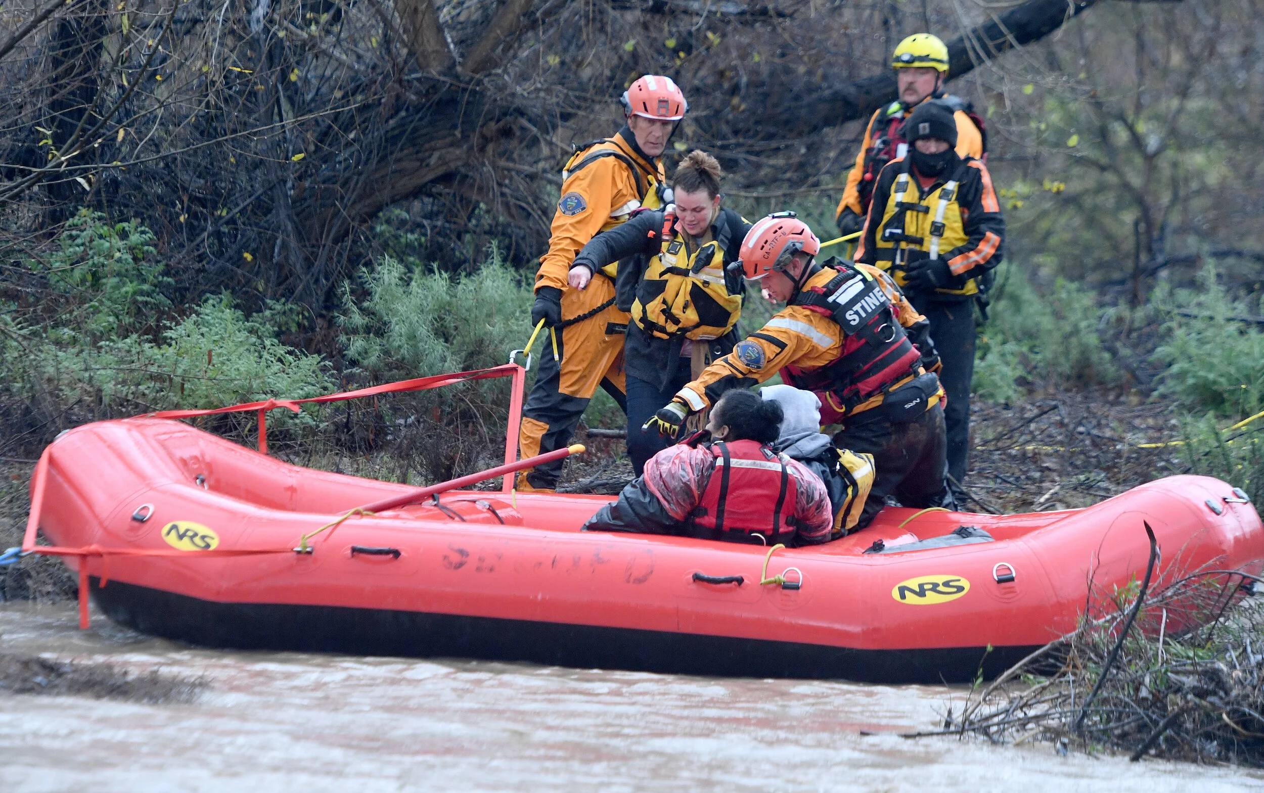  A San Bernardino County Fire swift rescue team rescued 8 individuals stranded on an island in the rain swollen Santa Ana River bed Thursday, February 14, 2019.  