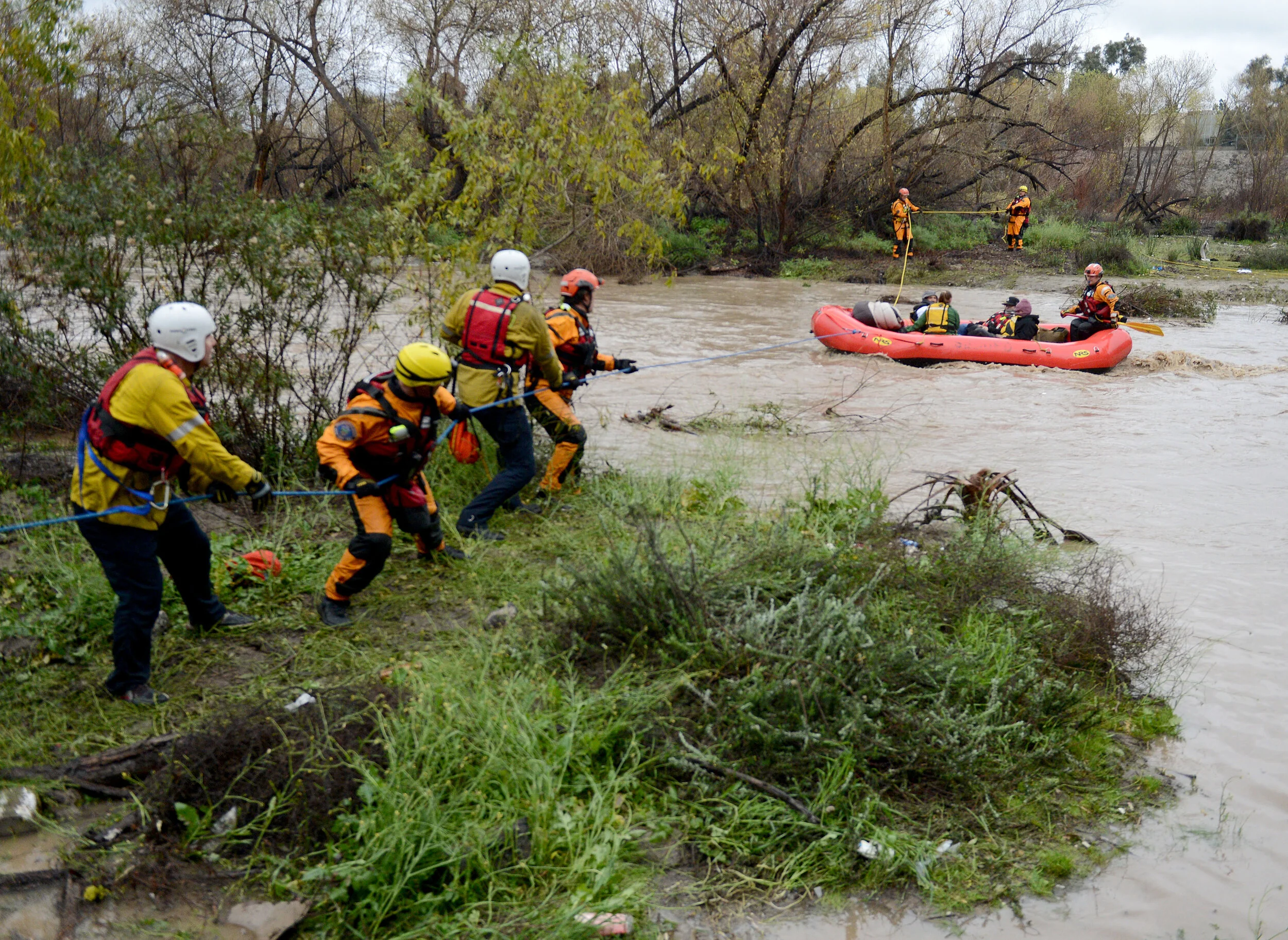  A San Bernardino County Fire swift rescue team rescued 8 individuals stranded on an island in the rain swollen Santa Ana River bed Thursday, February 14, 2019.  