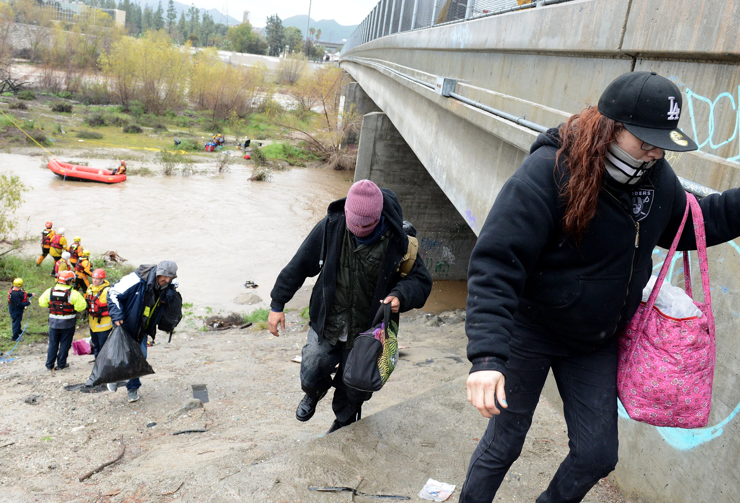  A San Bernardino County Fire swift rescue team rescued 8 individuals stranded on an island in the rain swollen Santa Ana River bed Thursday, February 14, 2019.  