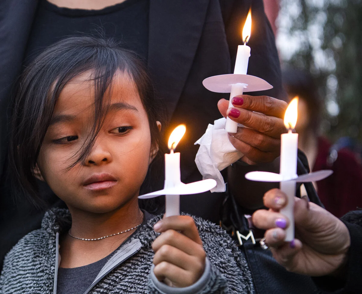  Tamelyn Truong, 6, looks over to her candle during a candlelight vigil for Landis Chase Lim, her brother, at MacArthur Park in Long Beach Monday, March 11, 2019. Lim who is 17 years old, was gunned down in Cambodia Town.  