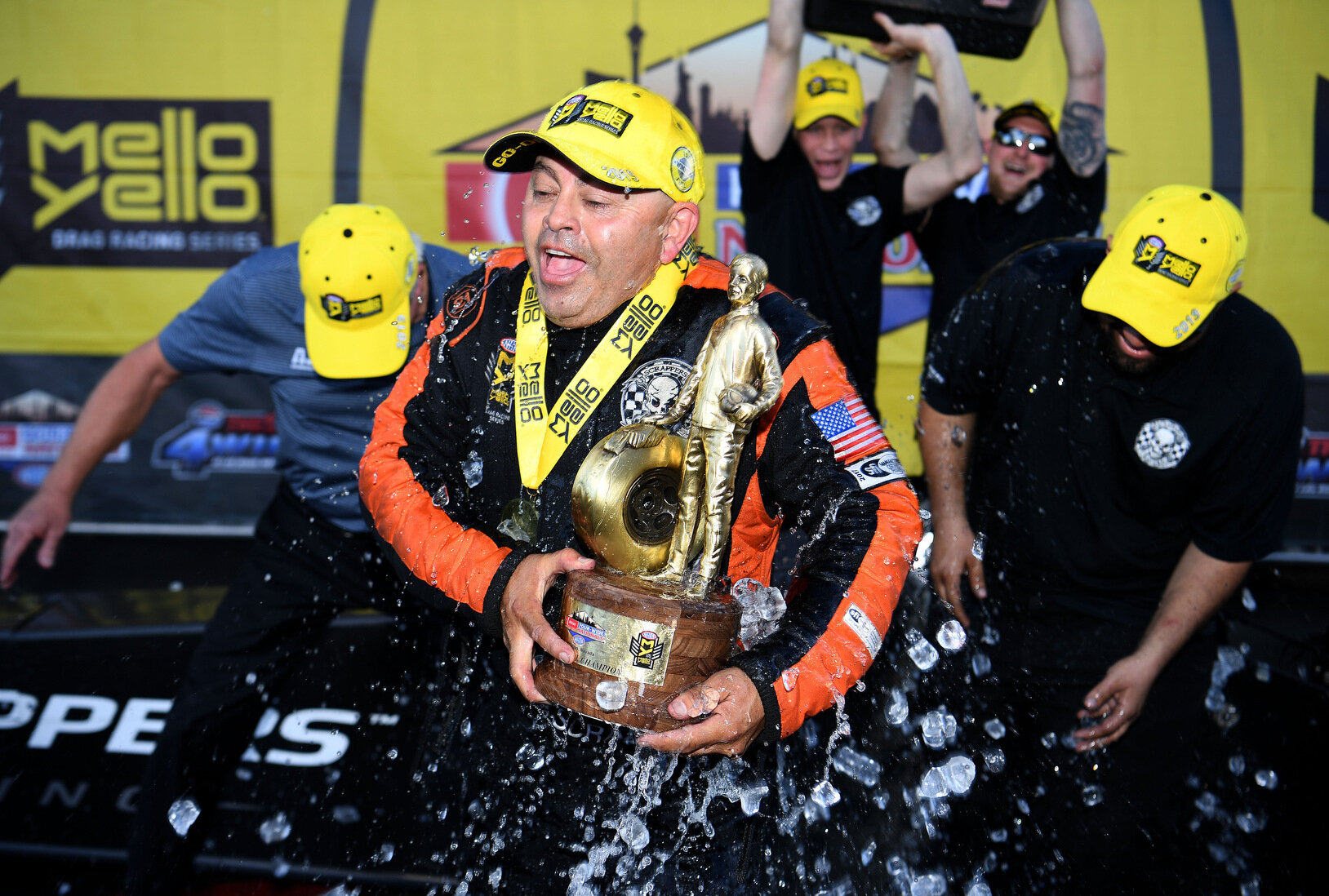  First time Top Fuel winner Mike Salinas, along with tuner Alan Johnson (left), is drenched with a cooler full of ice water by crew members in victory circle Sunday April 7, 2019 at the Denso Spark Plugs NHRA Four-Wide Nationals at The Strip at Las V