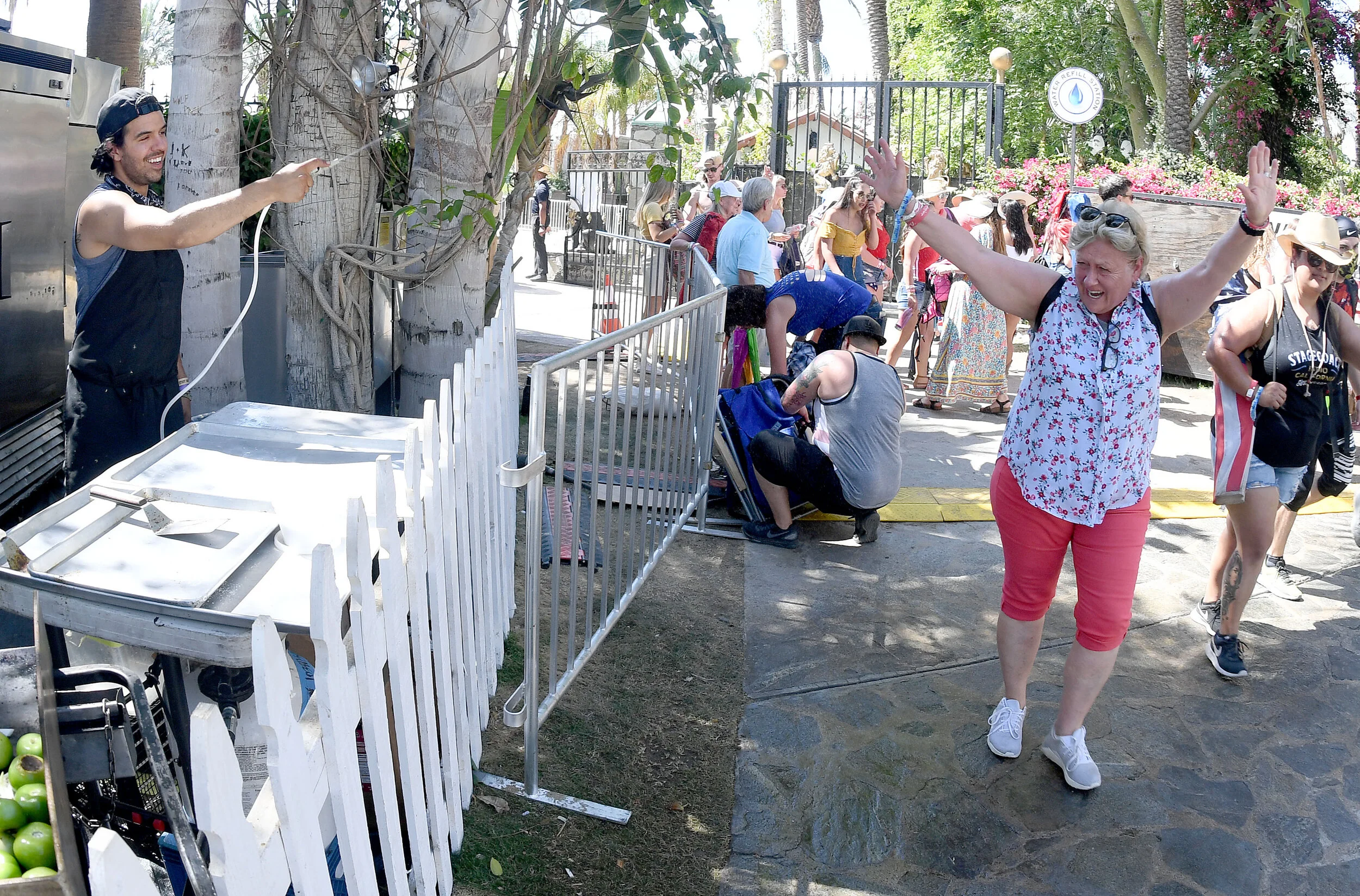  Country music fan Stefanie Sonico, from Cathedral City, gets sprayed with some cool water from Adrian Andres as she enter the Stagecoach Country Music Festival at the Empire Polo Club in Indio Saturday, April 27, 2019. Temperatures were expected to 