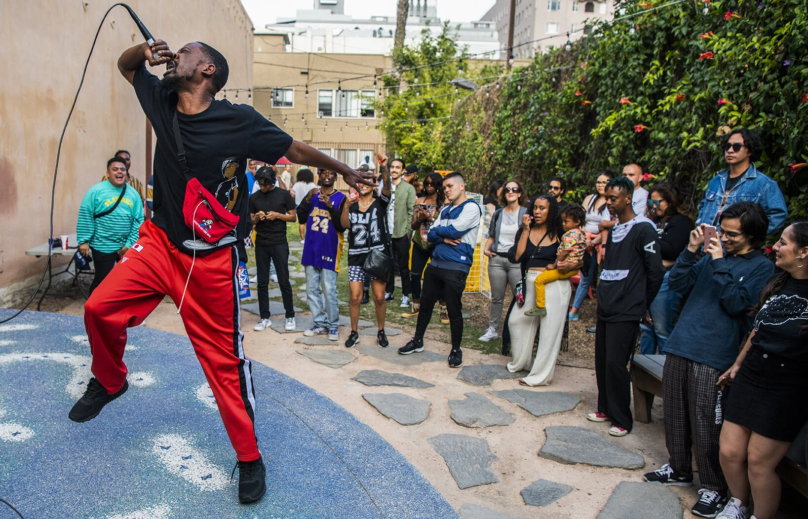  Hip-hop artist Red Bag works the whole stage as he performs with high energy at the East Village Arts Park during the East Village LB Artwalk in Long Beach Saturday, May 11, 2019.  