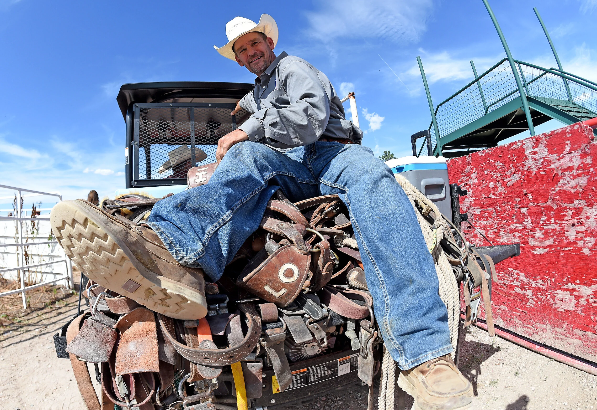  A cowboy sits atop a stack of tack gear Thursday July 25, 2019 following the 123rd Cheyenne Frontier Days Rodeo in Cheyenne, Wyoming.  
