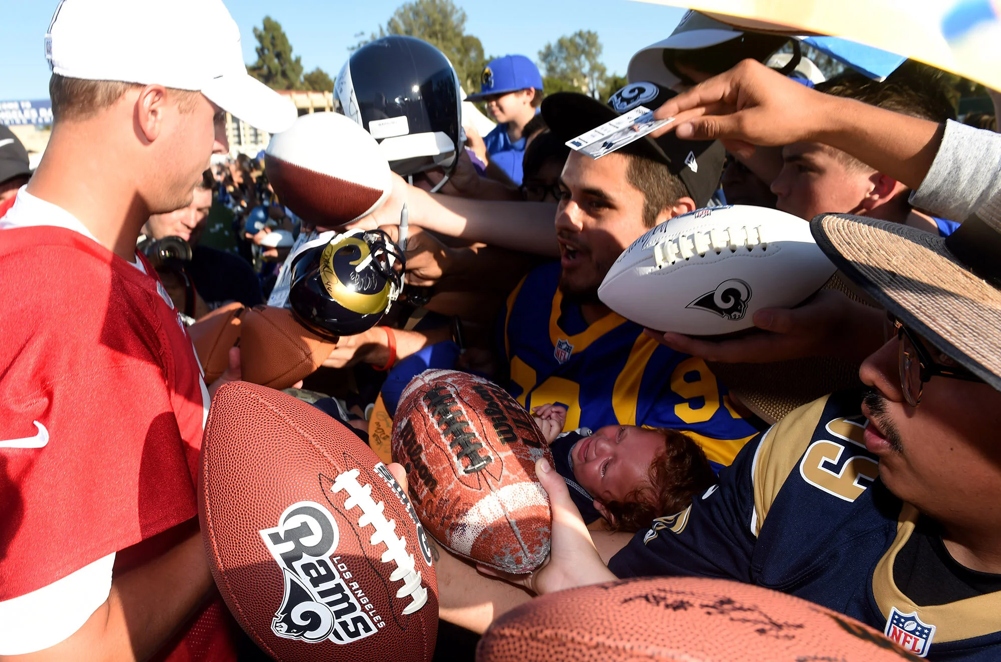  Quarterback Jared Goff #16 of the Los Angeles Rams sings a baby during the Los Angeles Rams training camp on the campus of UC Irvine on Saturday, July 27, 2019 in Irvine, California.  