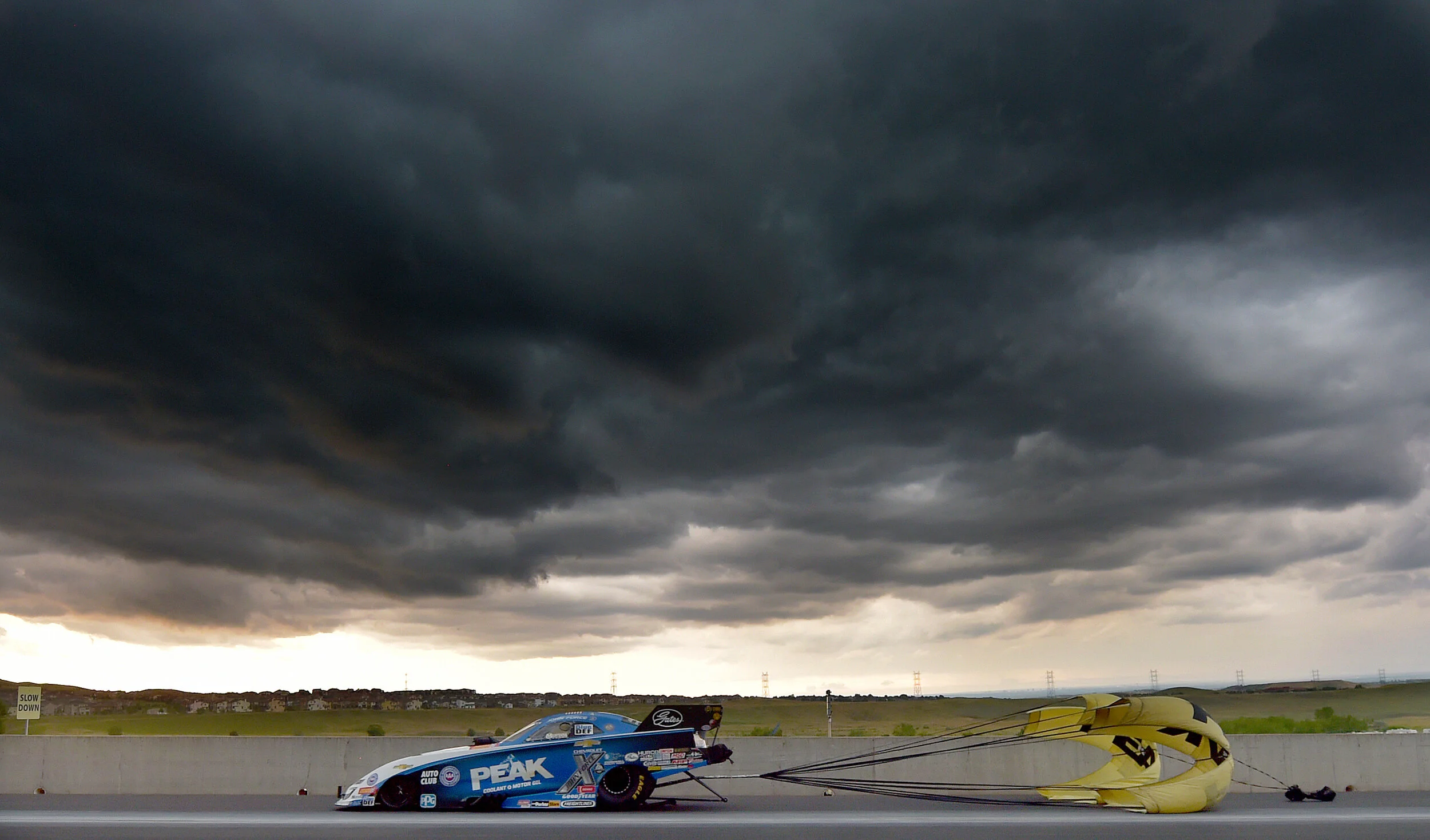  Funny Car driver John Force drives through the shutdown area under threatening skies during the third qualifying session Saturday July 20, 2019 at the Mile-High NHRA  Nationals at Bandimere Speedway in Morrison, Colorado.  