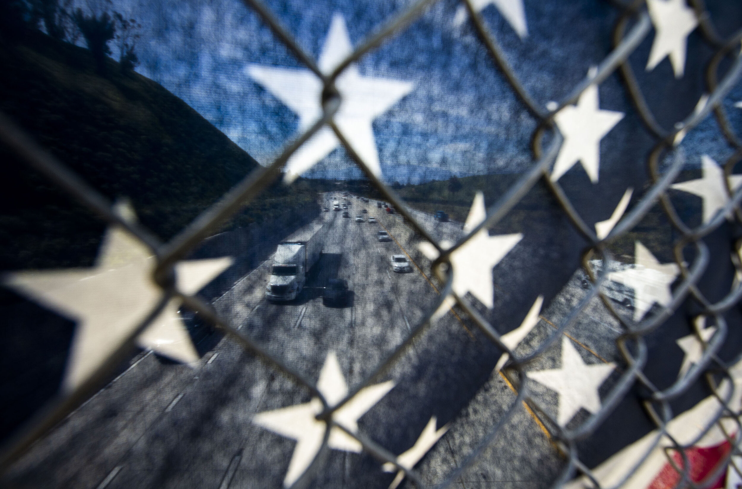  Traffic is moving on the I -10 freeway as the crossover lane is closed as seen through Old Glory on the Wabash Avenue in Redlands on Monday, April 1, 2019.  