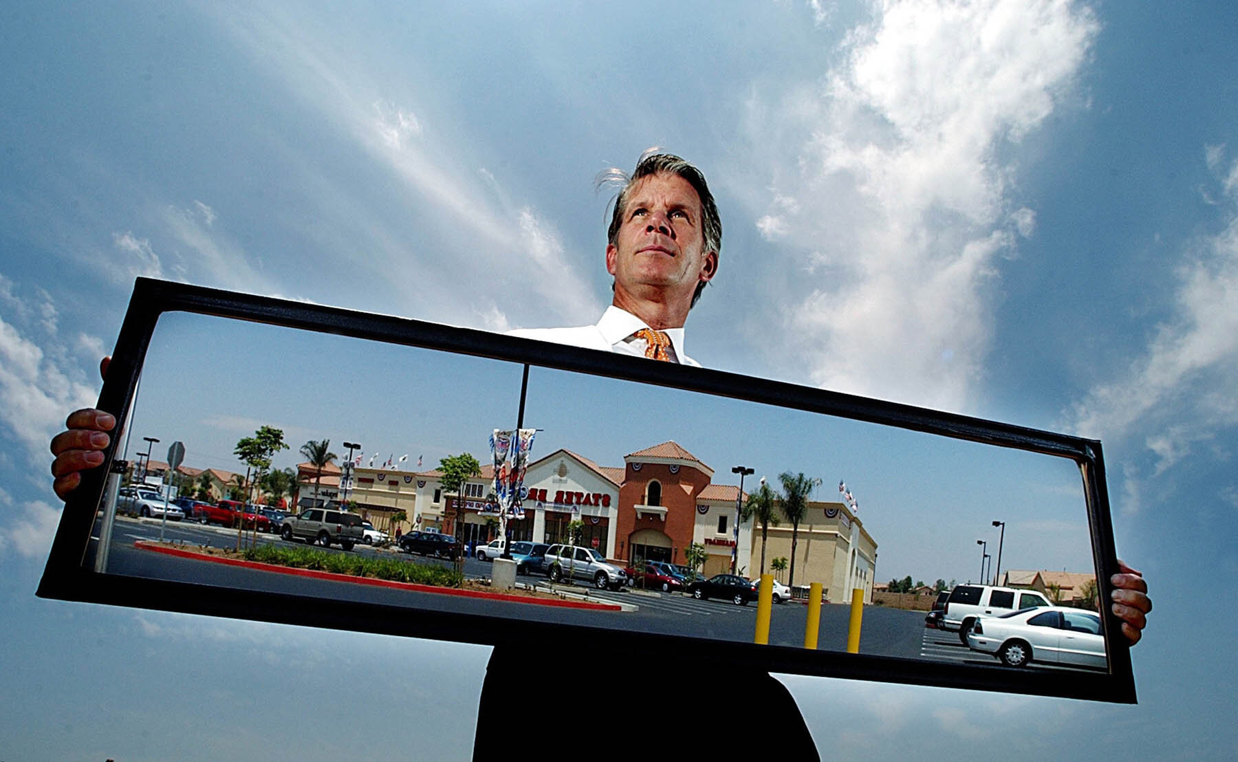  James Brooks, President of the Empire Commercial Real Estate, LP with a mirror reflecting a Stater Bros. shopping center he oversaw the development of in Moreno Valley.   