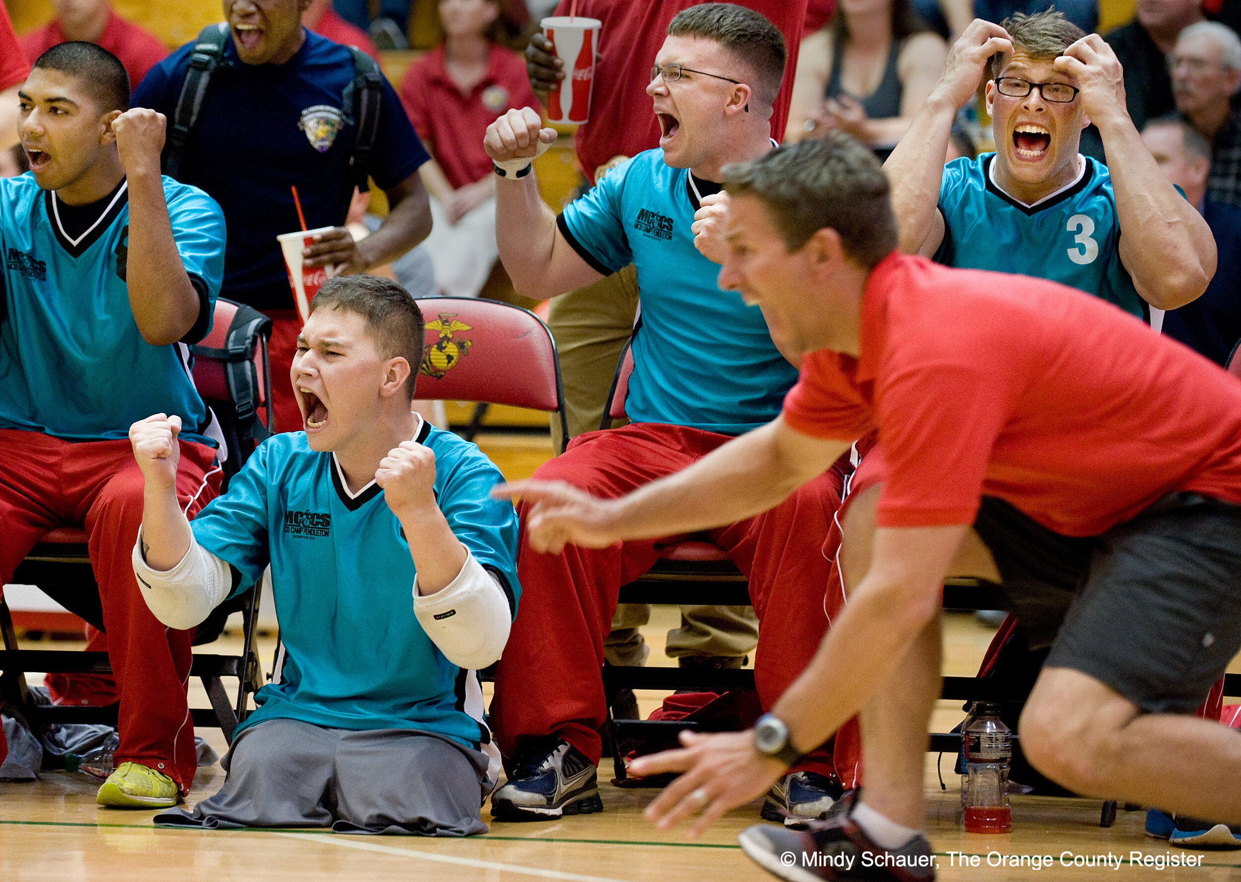  Pfc. Artem Lazukin celebrates winning a gold medal with his team, Battalion West, during the Wounded Warrior volleyball games at Camp Pendleton. Lazukin lost both legs when he stepped on an improvised explosive device in Afghanistan in 2011. More th