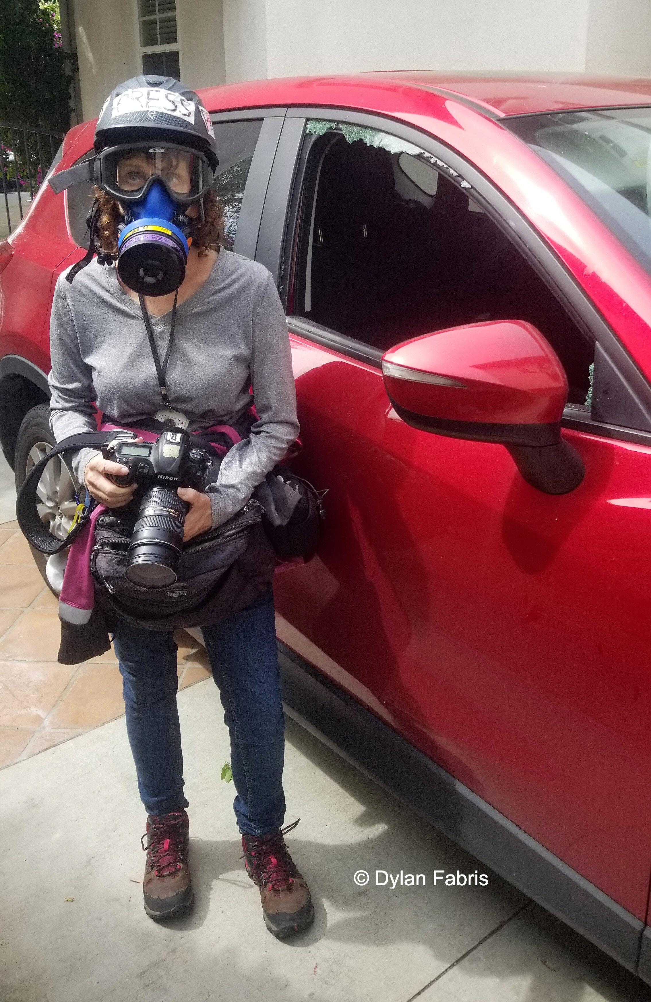  Orange County Register photographer Mindy Schauer is ready to cover protests. Her front passenger-side window was knocked out during the previous night’s riots. Photo by: Dylan Fabris 