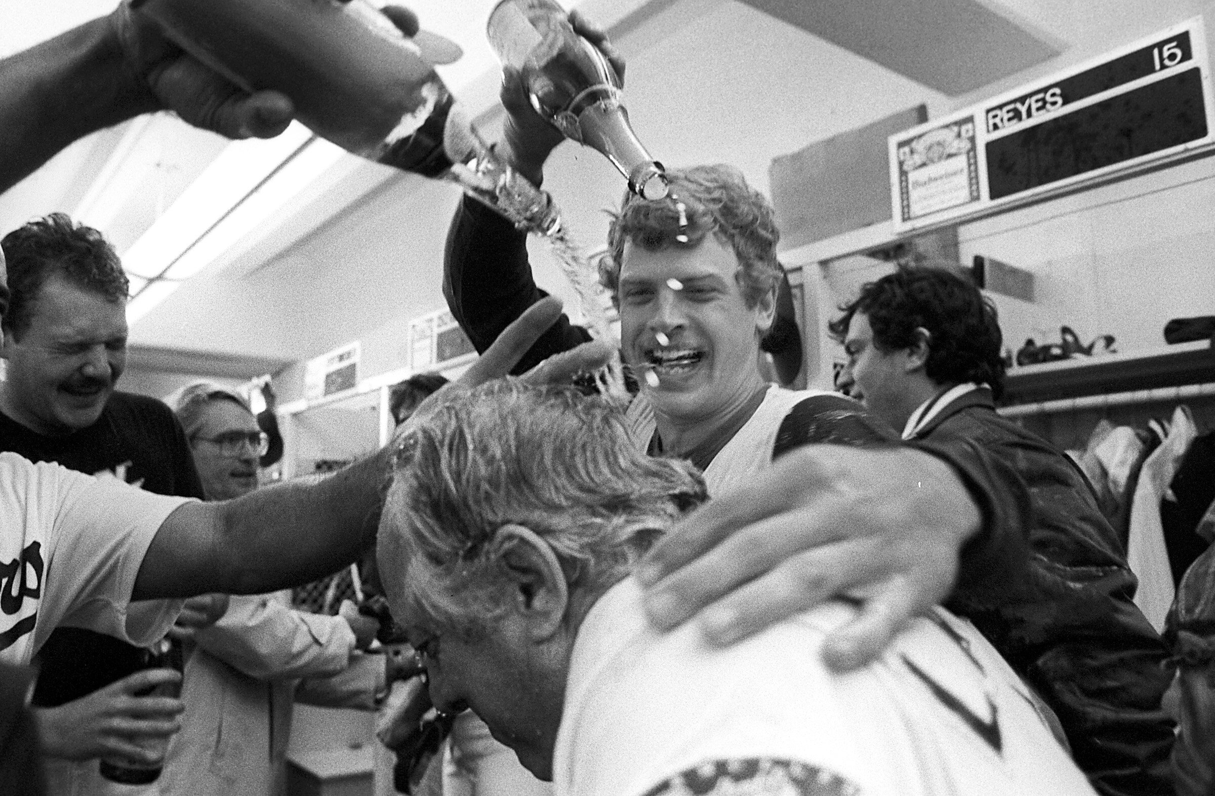  LOS ANGELES, CA - 1981: First baseman Greg Brock pours champagne on manager Tommy Lasorda #2 of the Los Angeles Dodgers in the clubhouse after winning the 1981 NLDS playoffs at Dodger Stadium, Los Angeles, California. (Photo by Jayne Kamin-Oncea/Get