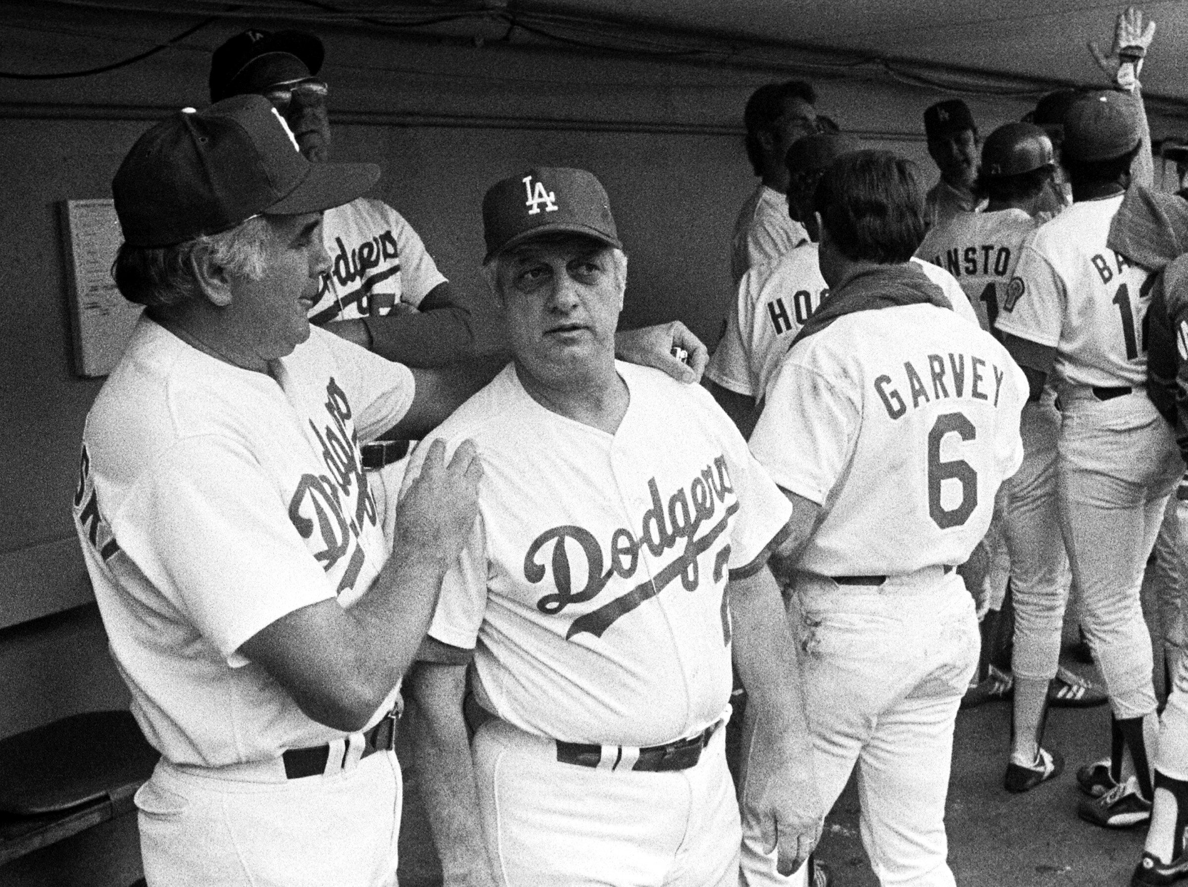  LOS ANGELES, CA - OCTOBER 1981: Pitching coach Ron Perranoski, manager Tommy Lasorda #2 and first baseman Steve Garvey #6 of the Los Angeles Dodgers in the dugout during the 1981 NLCS playoffs1981 at Dodger Stadium, Los Angeles, California. (Photo b