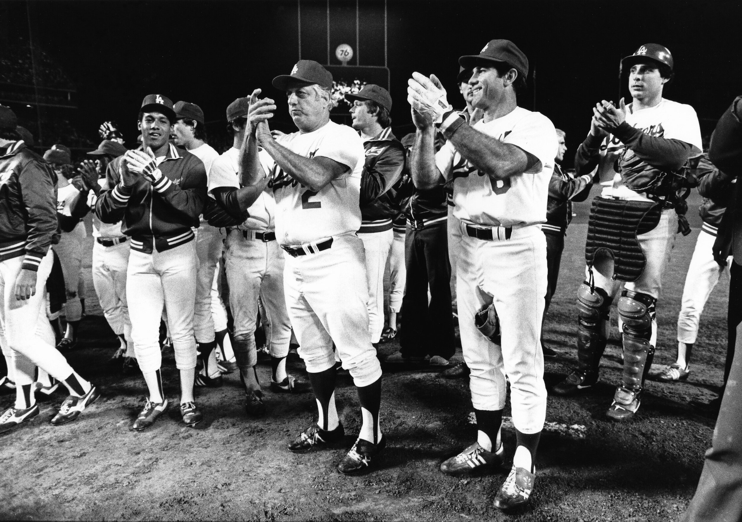  LOS ANGELES, CA - 1983: Candy Maldonado #20, Manager Tommy Lasorda #2, Steve Garvey #6 and Mike Scoscia #14 of the Los Angeles Dodgers acknowledge the crowd after playing the last game of the season at Dodger Stadium, Los Angeles, California. (Photo