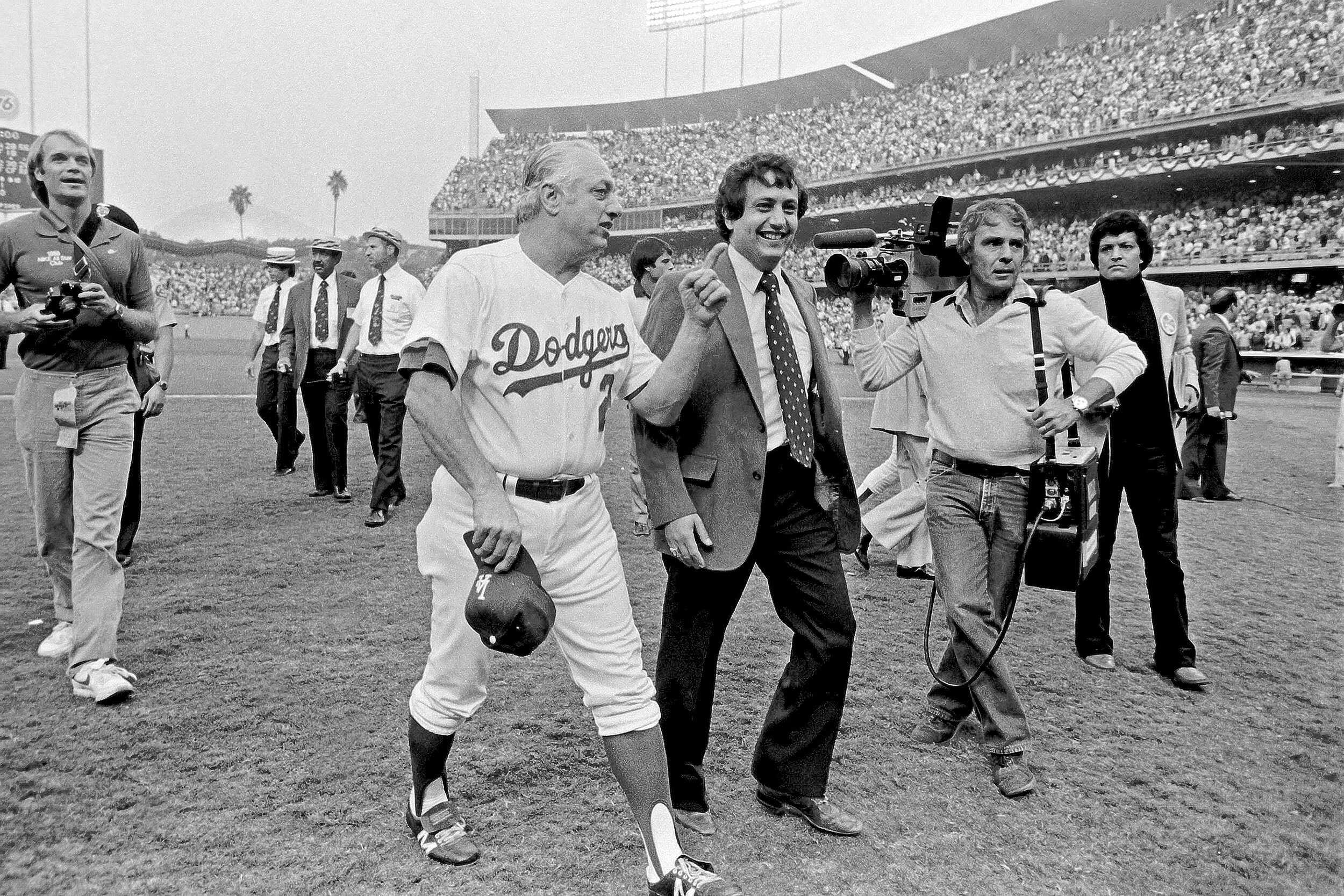  LOS ANGELES, CA - OCTOBER 25, 1981: Steve Brenner, head of public relations, talks with manager Tommy Lasorda #2 of the Los Angeles Dodgers as he walks off the field after defeating the New York Yankees in game 5 of the 1981 World Series at Dodger S