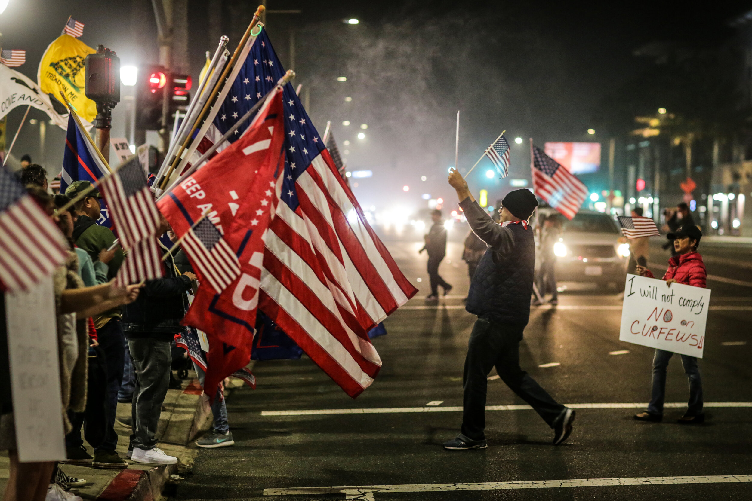  Huntington Beach, CA, Saturday, November 21, 2020 - As Covid-19 cases reach record numbers in the U.S. and California, hundreds protest a State mandated curfew of 10 pm.  Following the lead of President Donald Trump, “Covid deniers” gathered, unmask