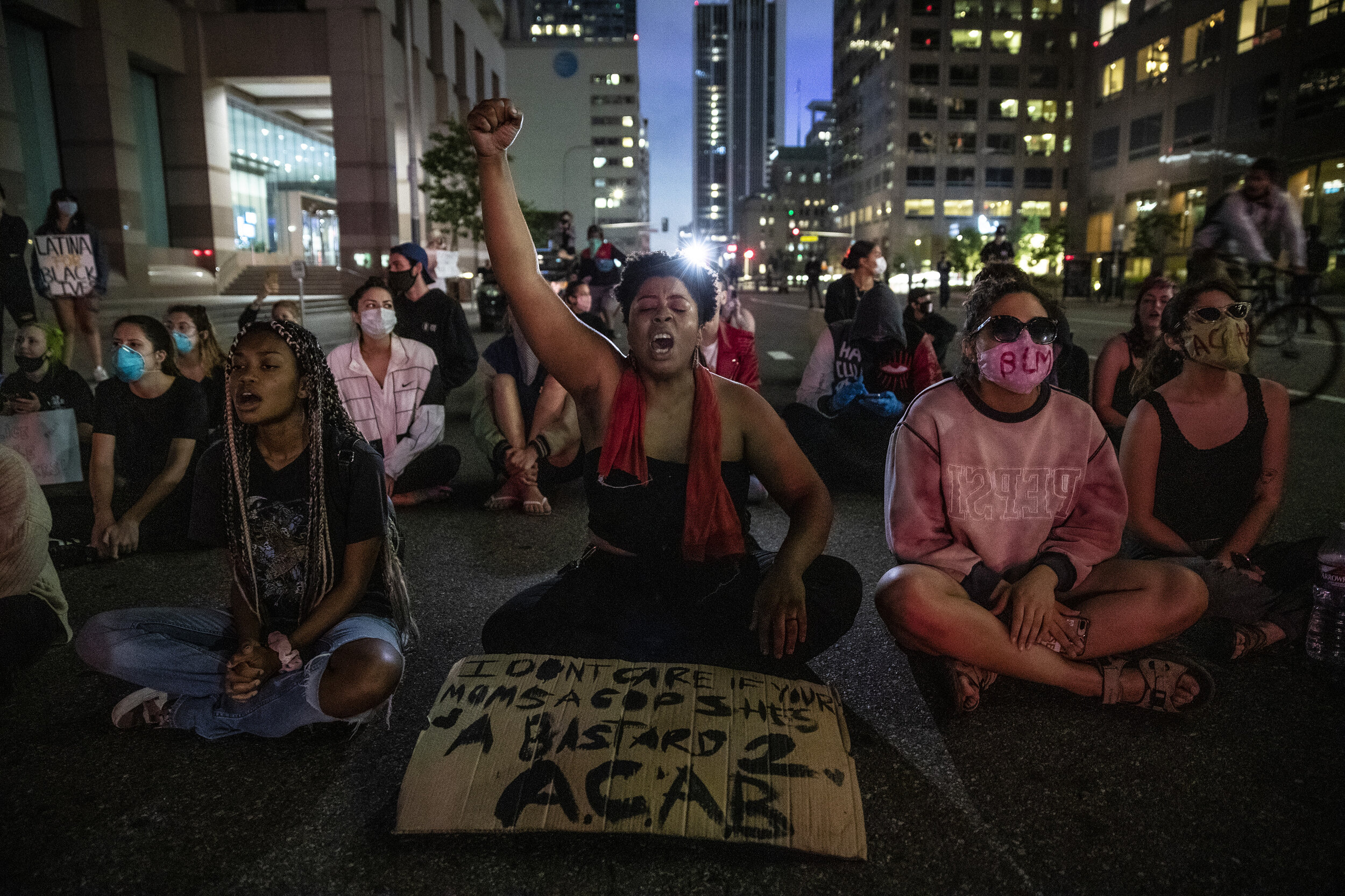  Elyssa Wells yells out protesting the death of George Floyd as she sits with others on Grand Ave., downtown Los Angeles, June 28, defying police orders to leave the area.  The group finally dispersed after LAPD officers moved to clear the streets. A