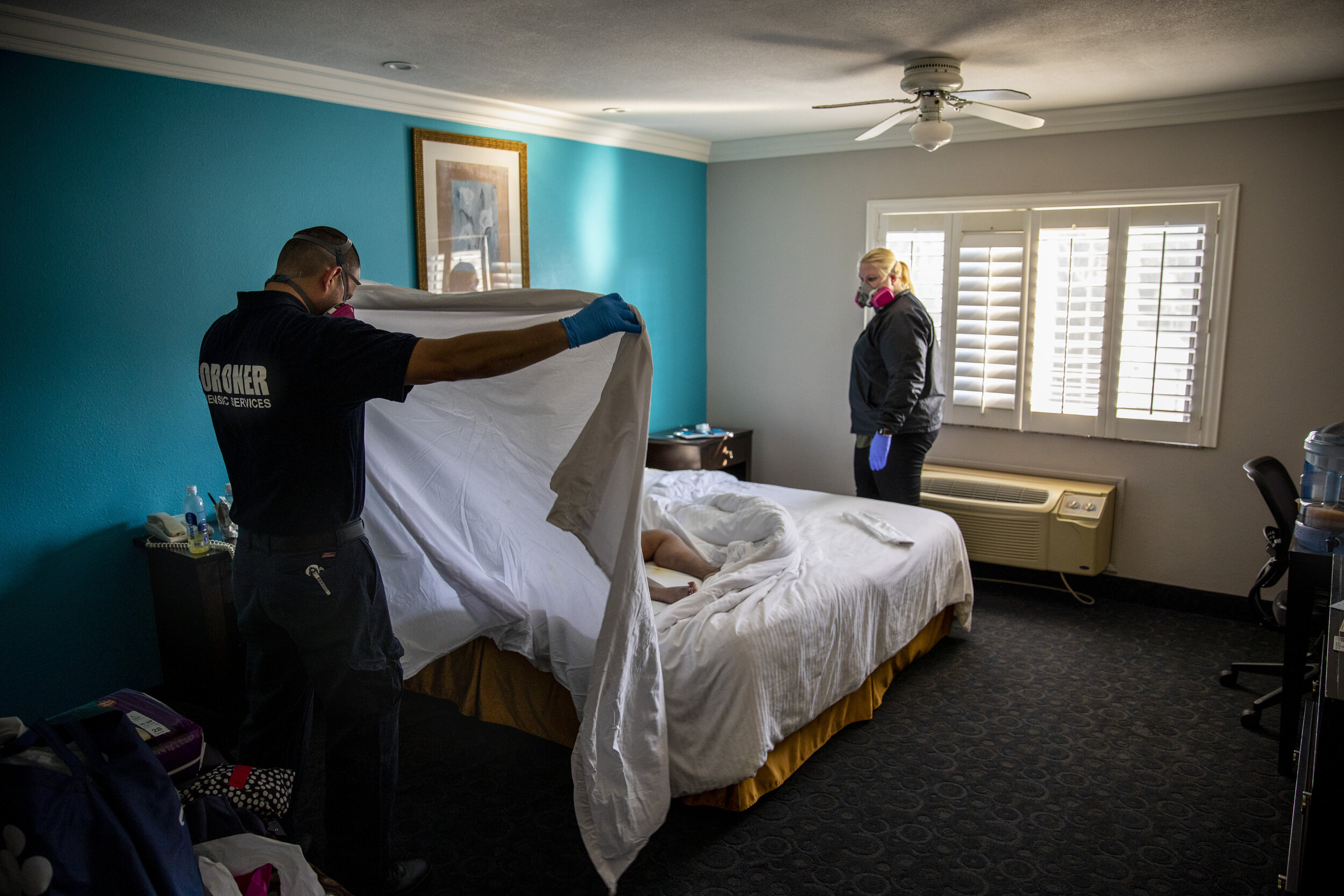  Kristina McGuire, an investigator with the Los Angeles County Dept. of Medical Examiner-Coroner, right and Jerry Meza, forensic attendant, prepare to wrap and transport the lifeless body of Judy Bounthong, 58, an ob-gyn tech at Emanate Queen of the 