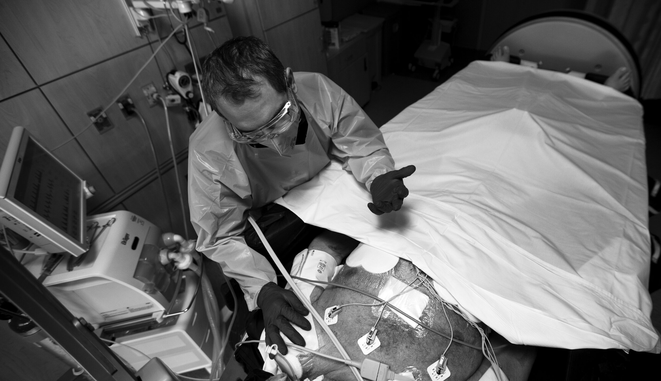  Chaplain Kevin Deegan, left, prays over patient Bob Harris as Bob family is participating via an iPad on Thursday, Dec. 3, 2020 in Mission Hills, CA. Bob has been on a ventilator for over 30 days. He is in a rotoprone bed that will rotate him to a p