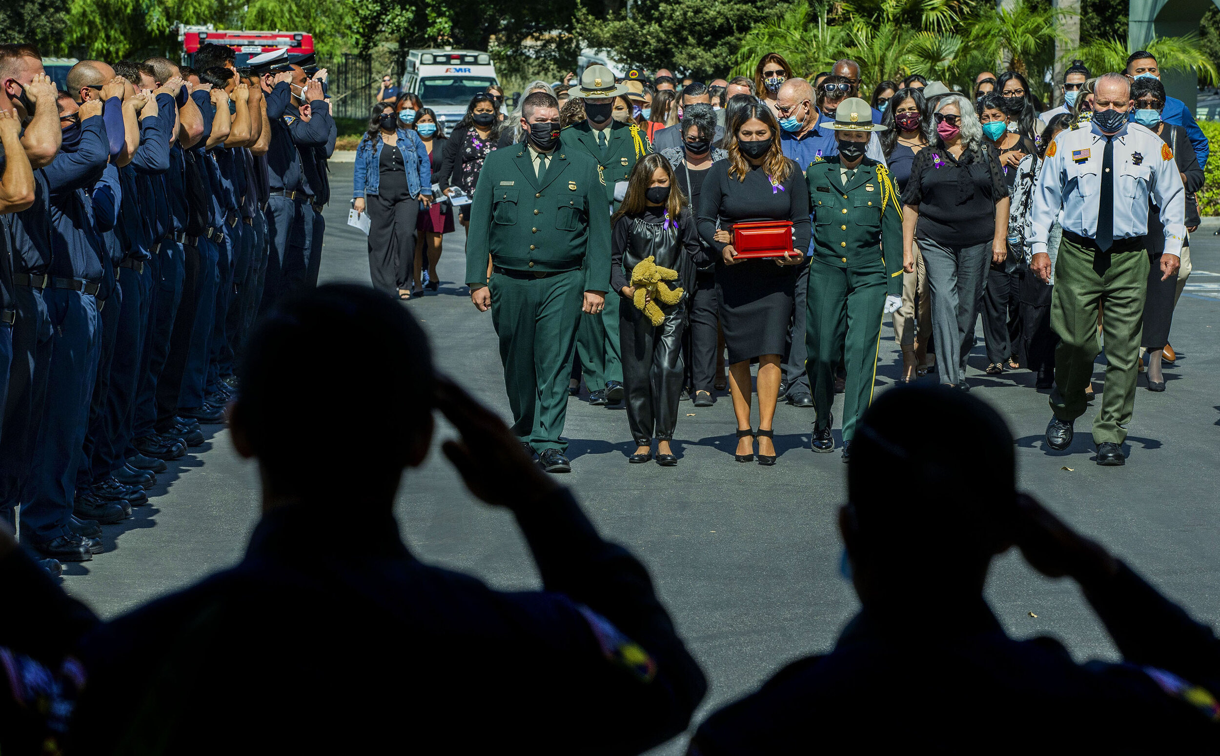  U.S. Forest Service Big Bear Hotshot Charles Morton was killed in the line of duty on Sept. 17 fighting the El Dorado Fire. Firefighters salute as Morton’s fiancee, Monica Tapia carries his urn during his memorial service at The Rock Church in San B