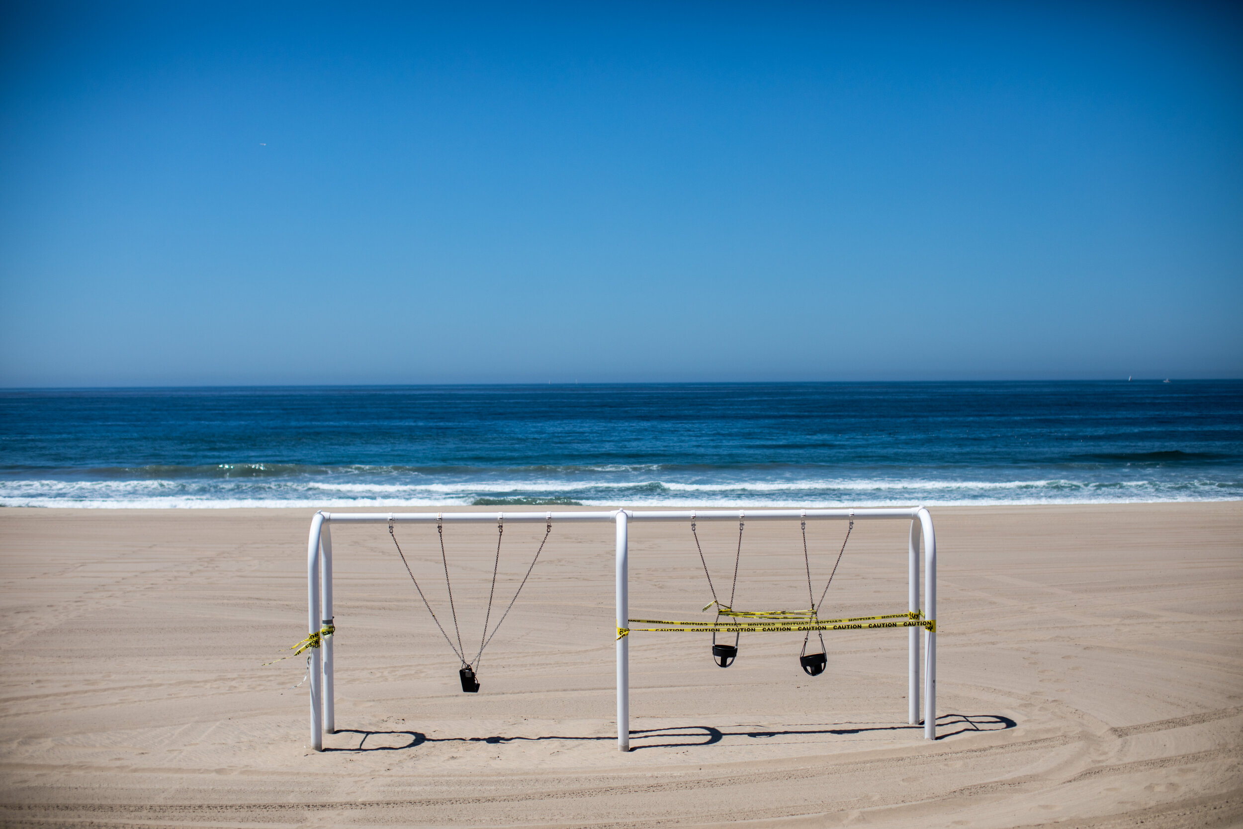  With California’s COVID-19 positive cases rising, stay-at-home orders are kept in place, with playgrounds included in the lock-down. A sign of our civid-times, swings are secured and taped off in Manhattan Beach, CA, during the coronavirus pandemic,