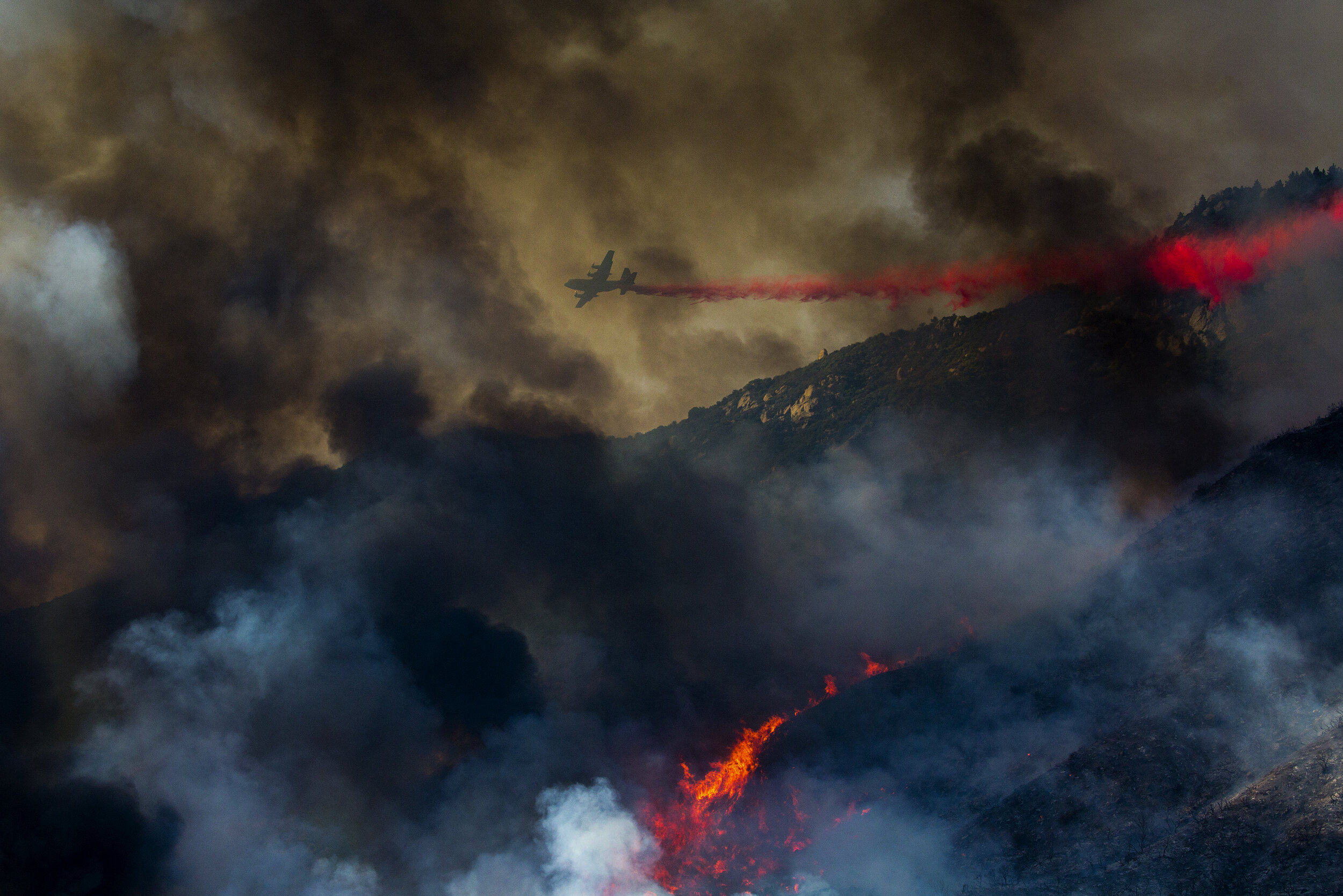  An air tanker drops retardant at a wildfire burns at a hillside in Yucaipa, Calif., Saturday, Sept. 5, 2020. The 2020 California wildfire season was characterized by a record-setting year of wildfires that burned across the state of California as me