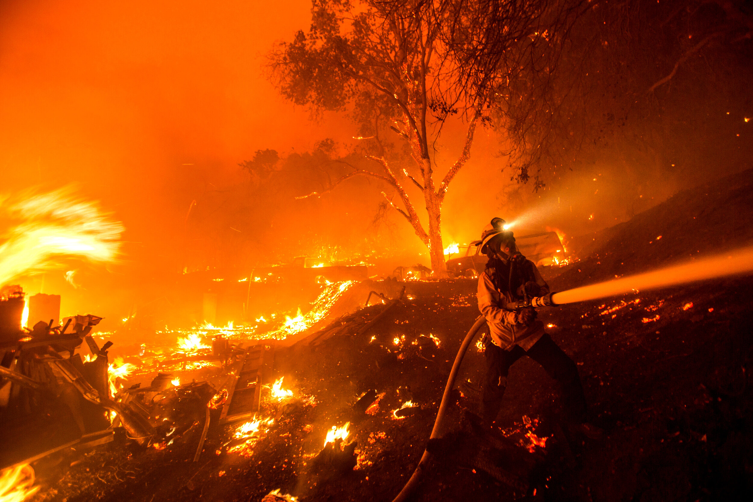  A firefighter battles the Lake Hughes fire in Angeles National Forest on Wednesday, Aug. 12, 2020, north of Santa Clarita, Calif. The 2020 California wildfire season was characterized by a record-setting year of wildfires that burned across the stat
